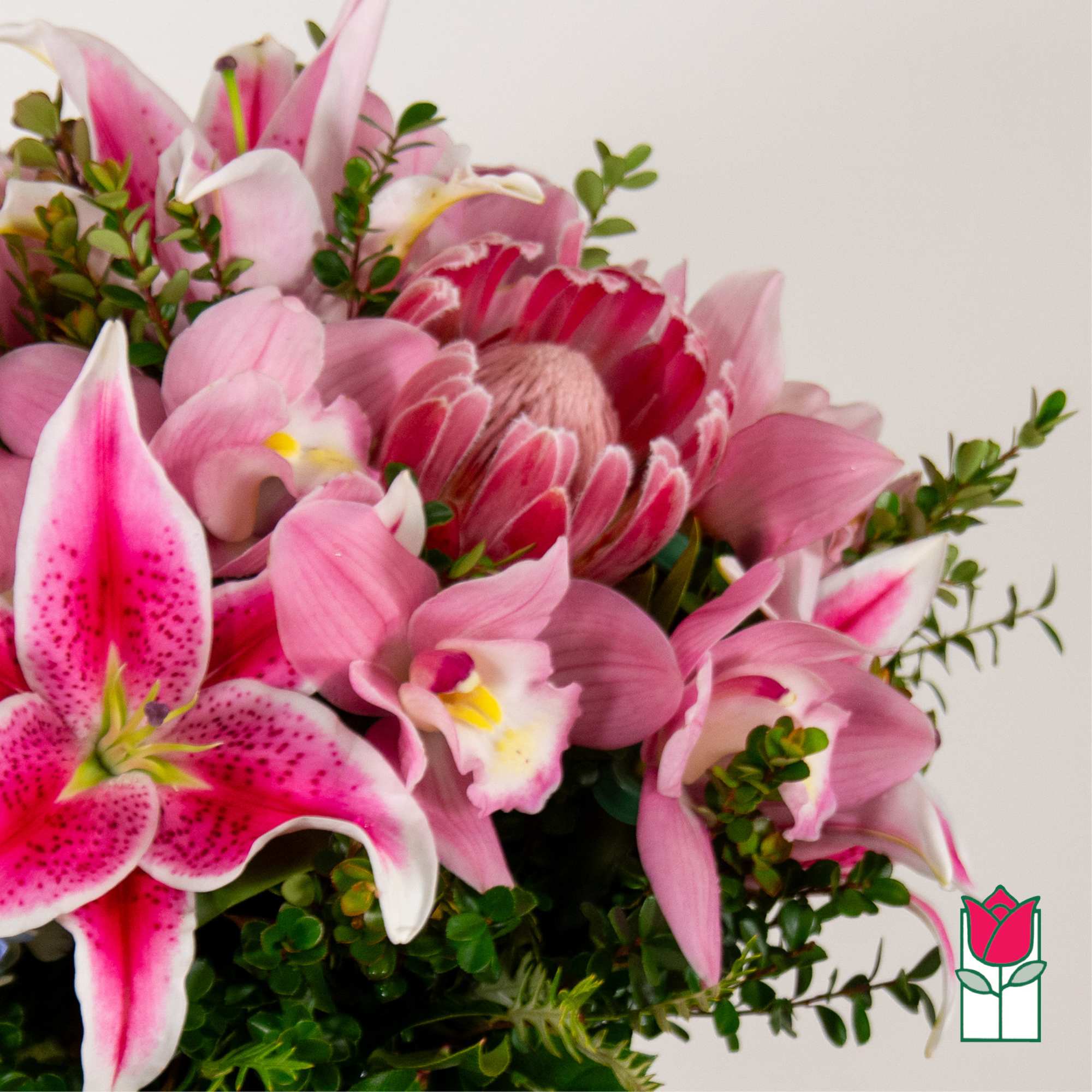 Pink lilies and a protea in a mixed bouquet