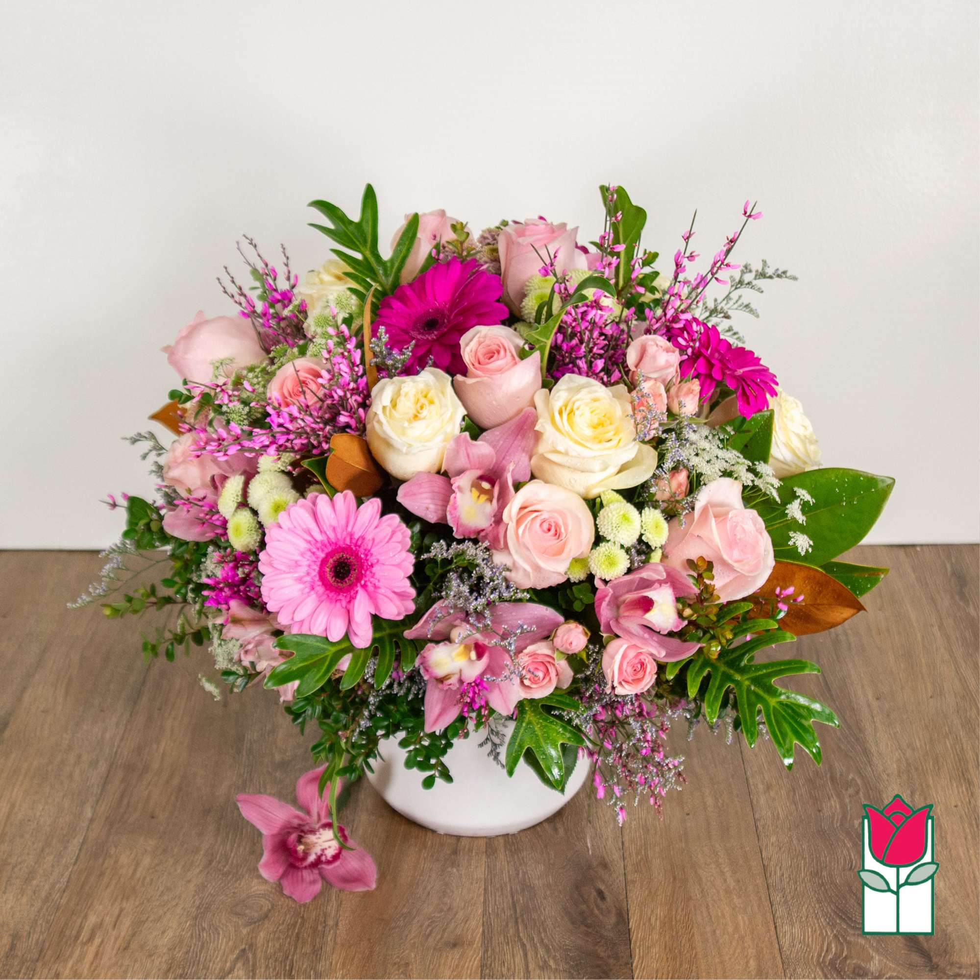 Pink and white mixed flower arrangement in a white vase