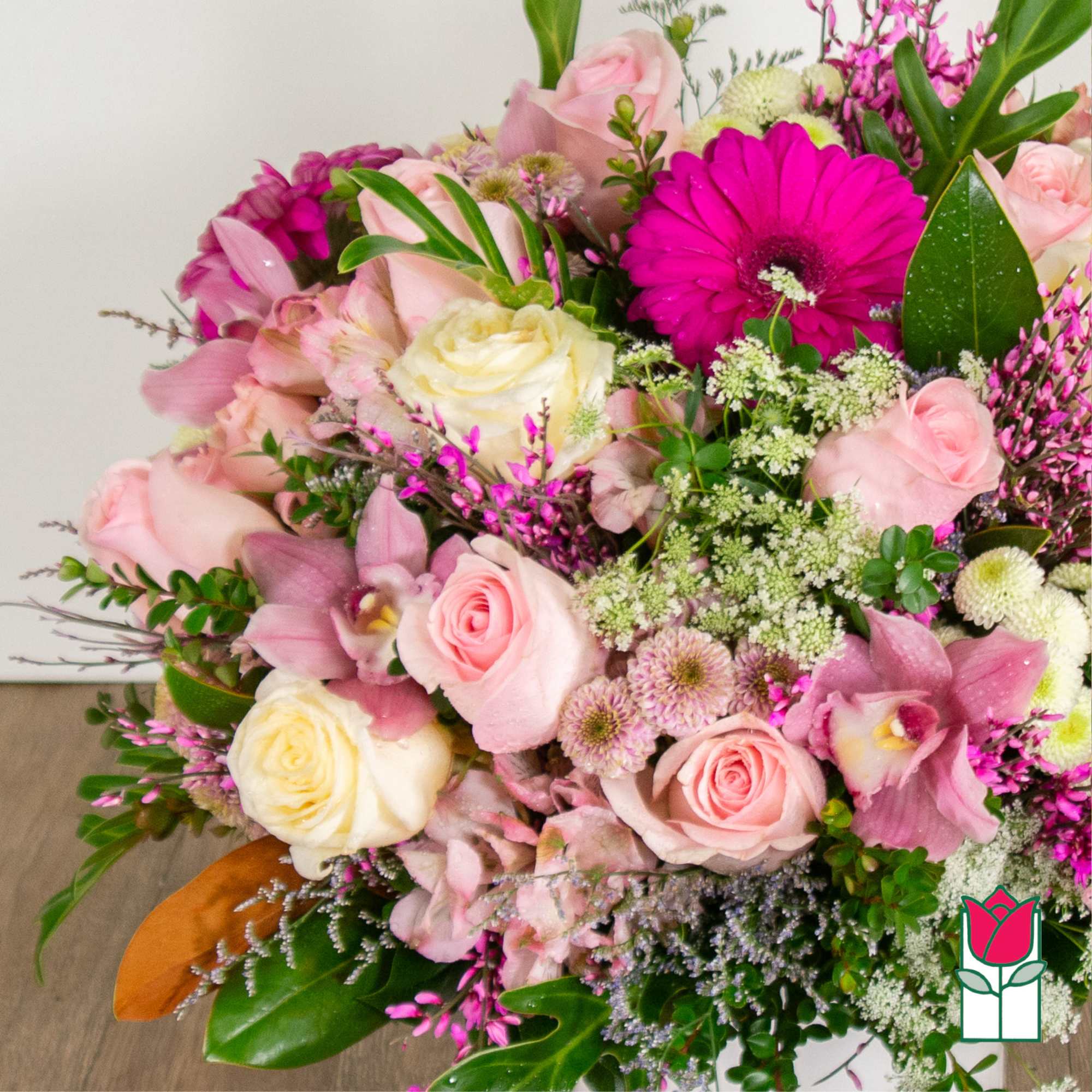 Bouquet of pink and white roses with a bright magenta gerbera daisy