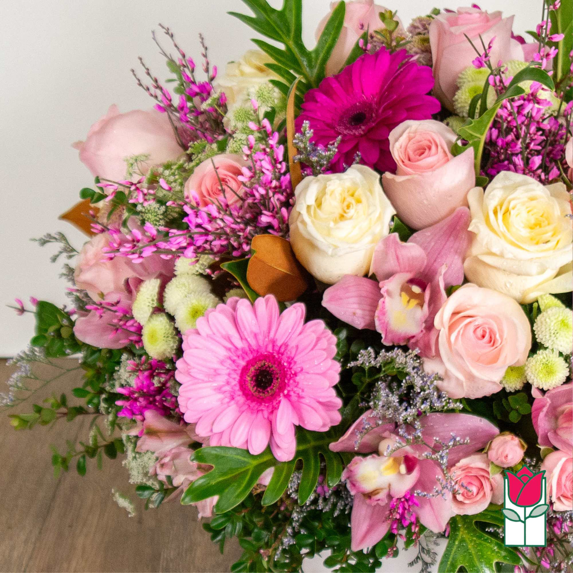 Pink and cream bouquet with roses, gerbera daisies, and orchids