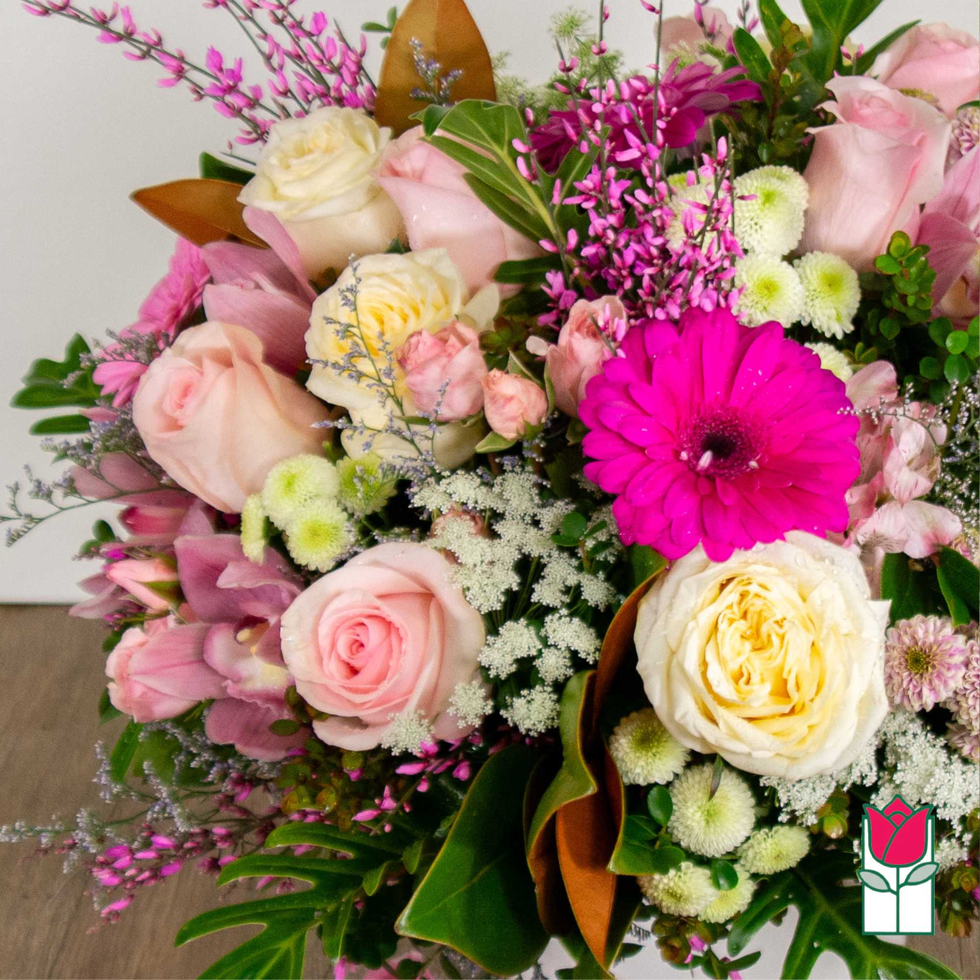 Pink and cream rose bouquet with a bright magenta gerbera daisy