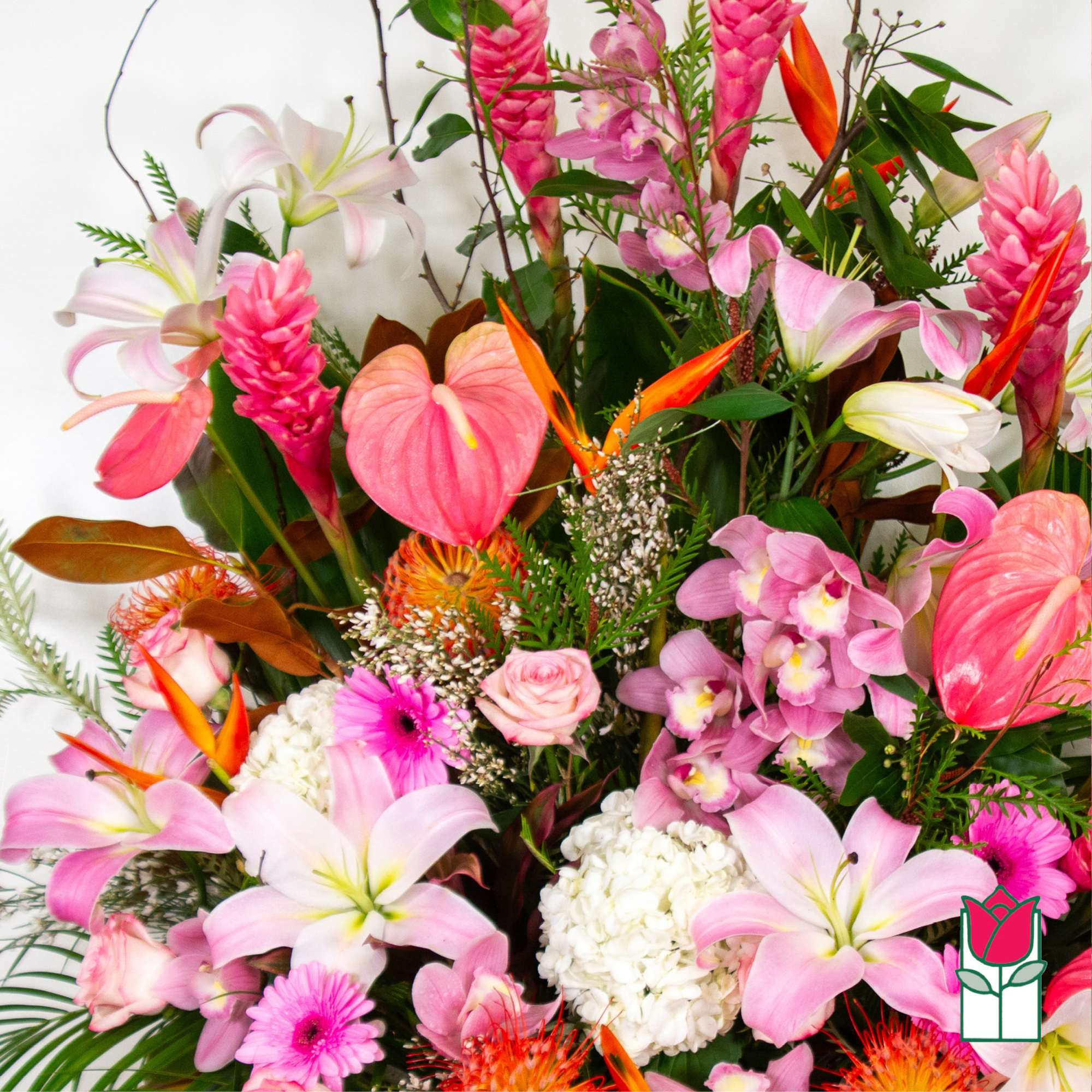 Tropical bouquet with pink lilies, orchids, and orange bird-of-paradise