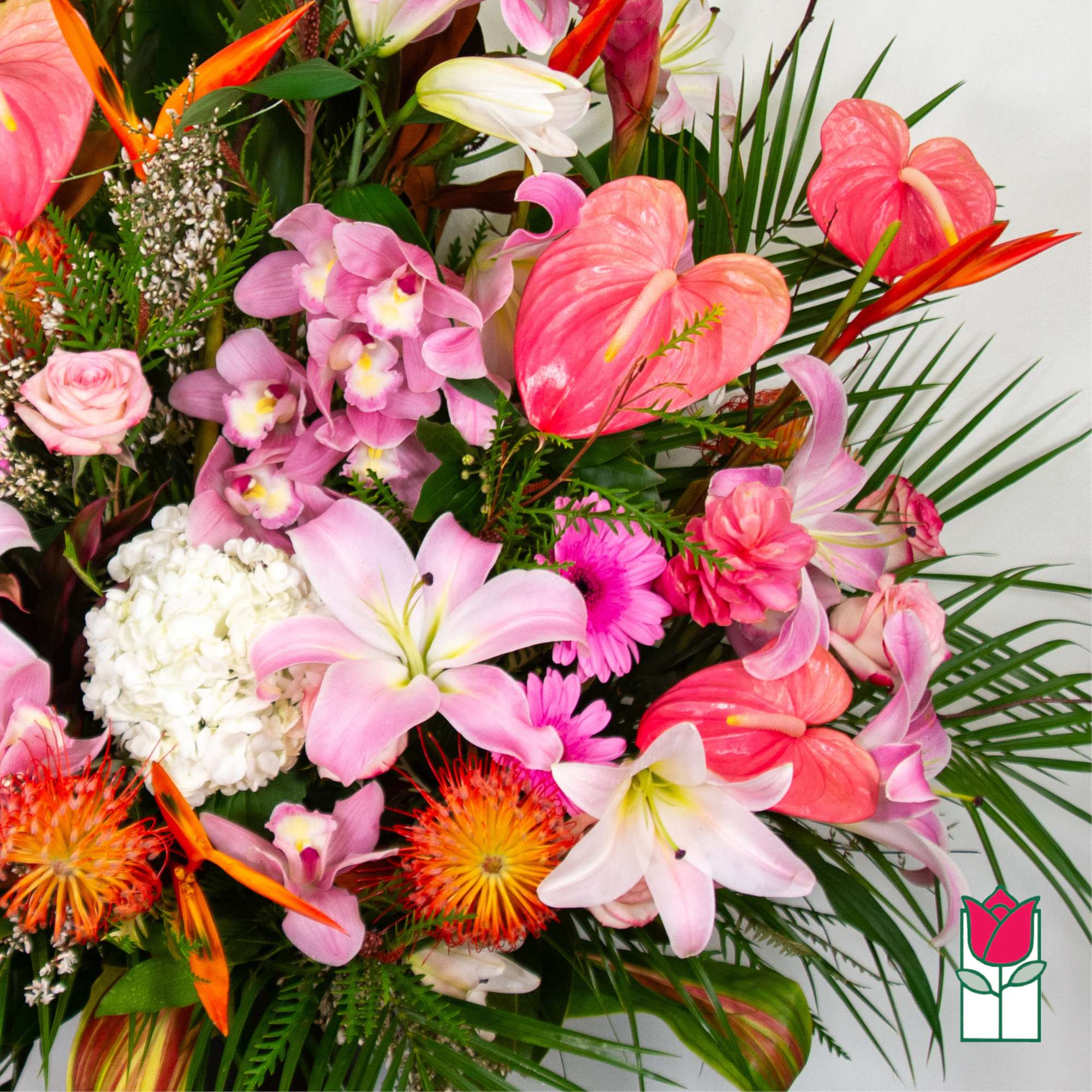 Tropical bouquet with pink anthuriums, orchids, lilies, and orange bird-of-paradise
