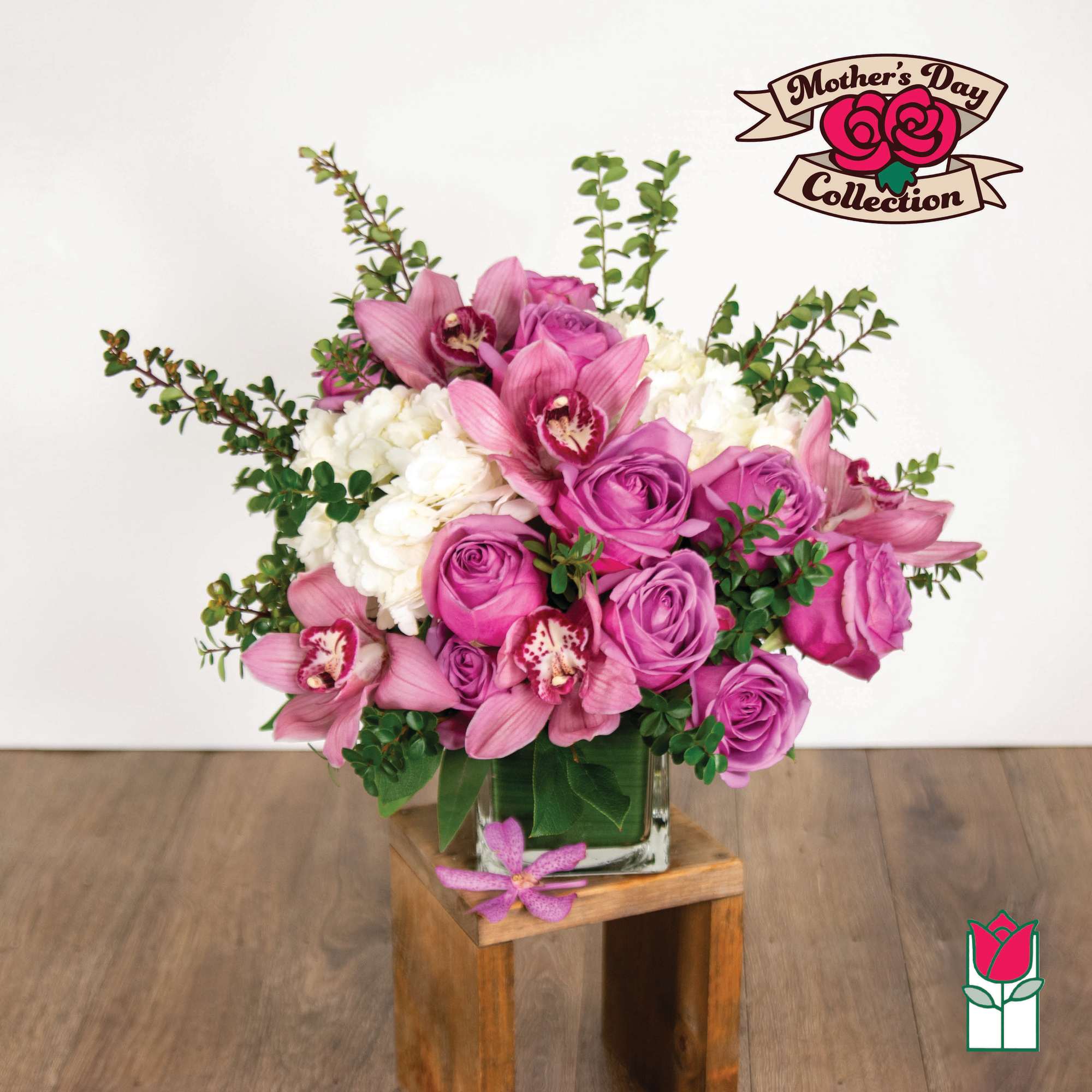 Pink roses and orchids arranged in a glass vase