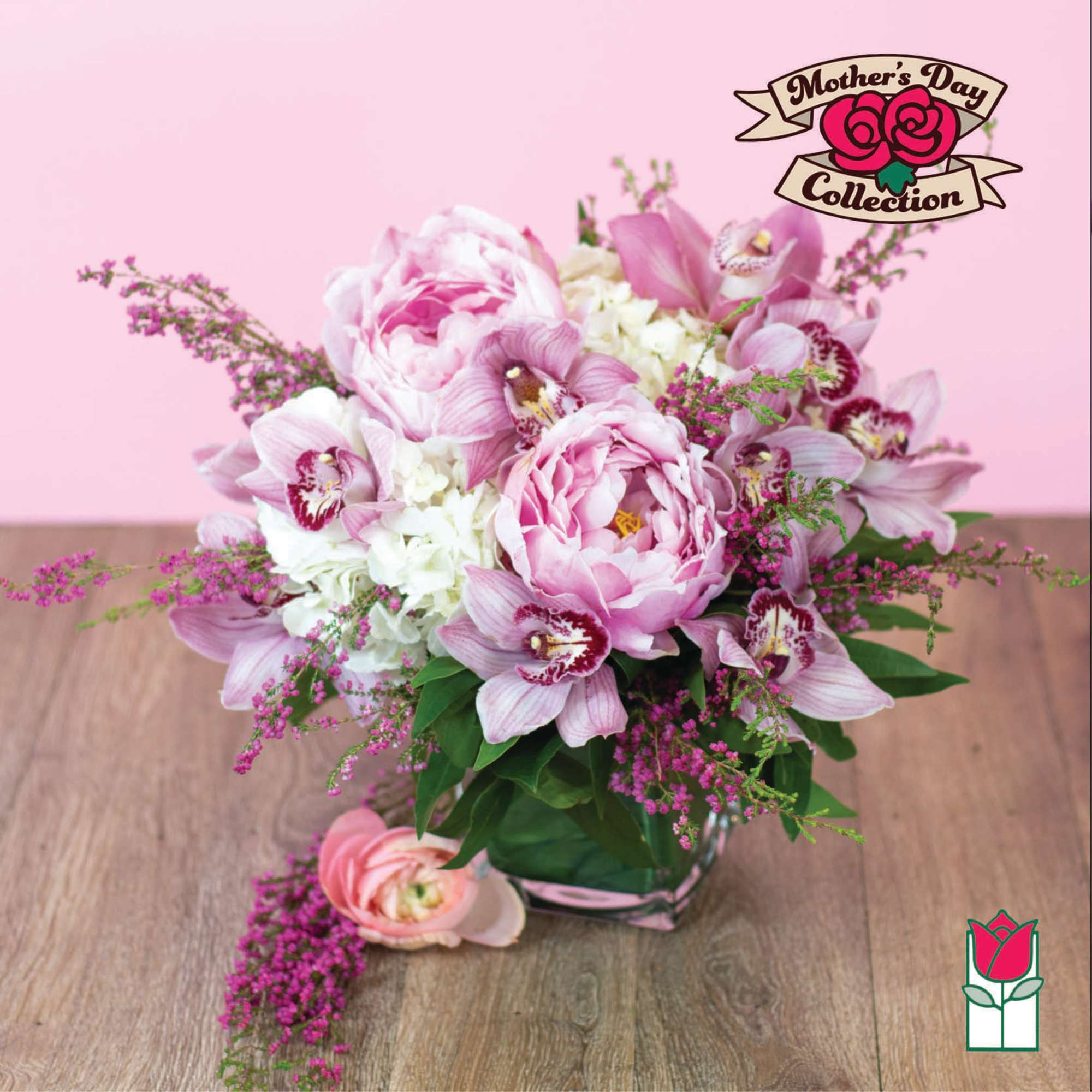 Pink peonies and orchids arranged in a glass vase