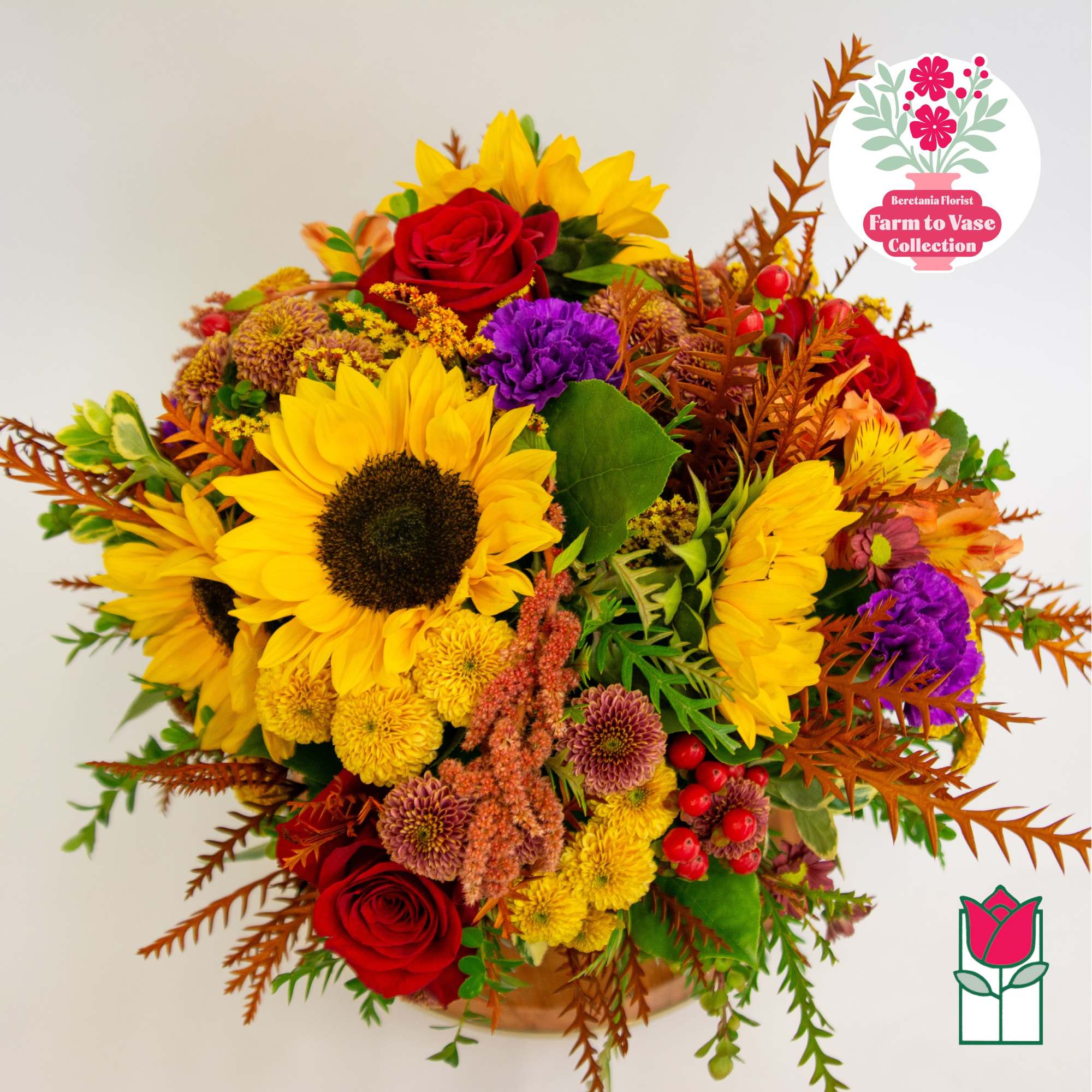 Bouquet with sunflowers, red roses, and purple mums in a basket