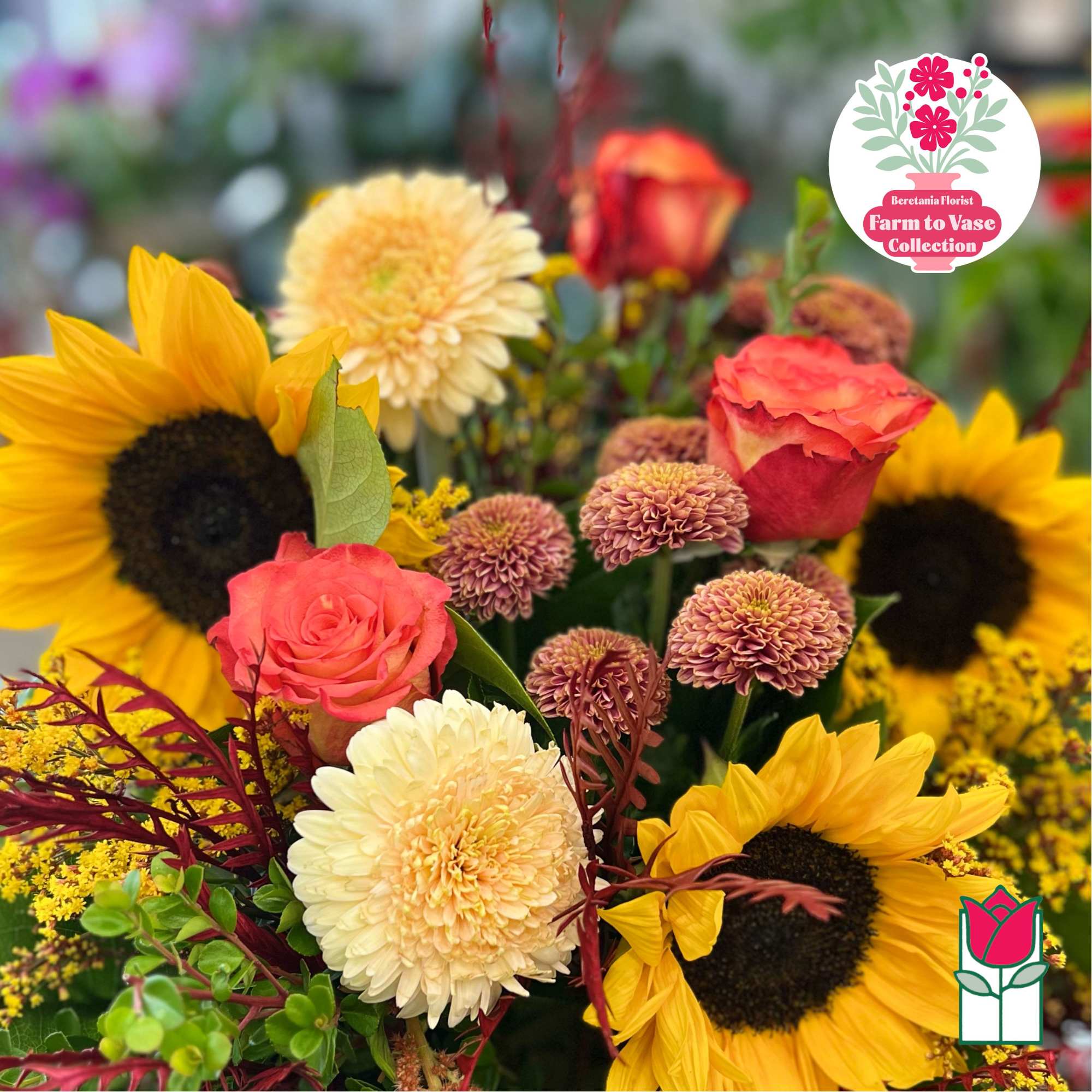 Bouquet with sunflowers, coral roses, and cream chrysanthemums