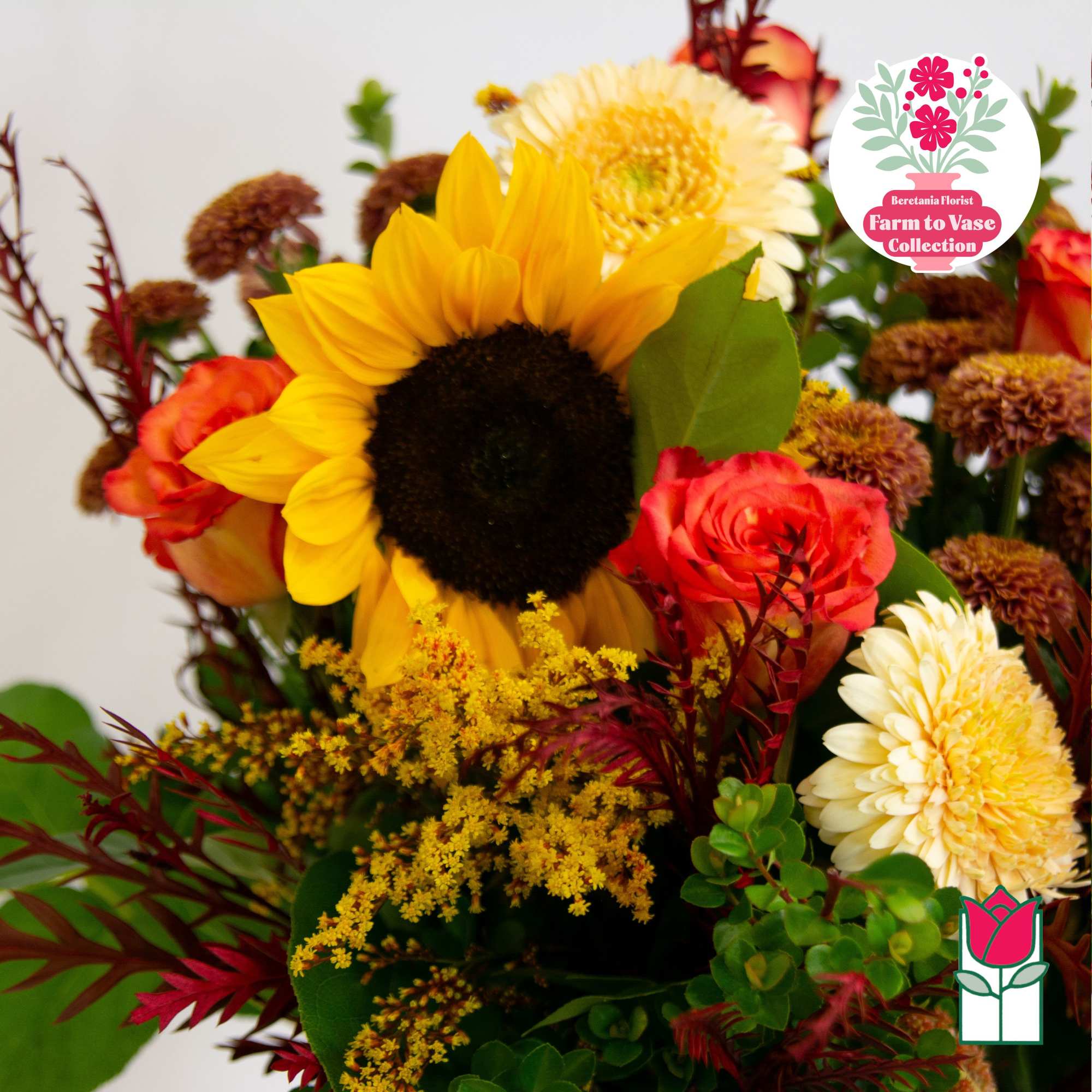 Bouquet with a sunflower, roses, and cream chrysanthemums