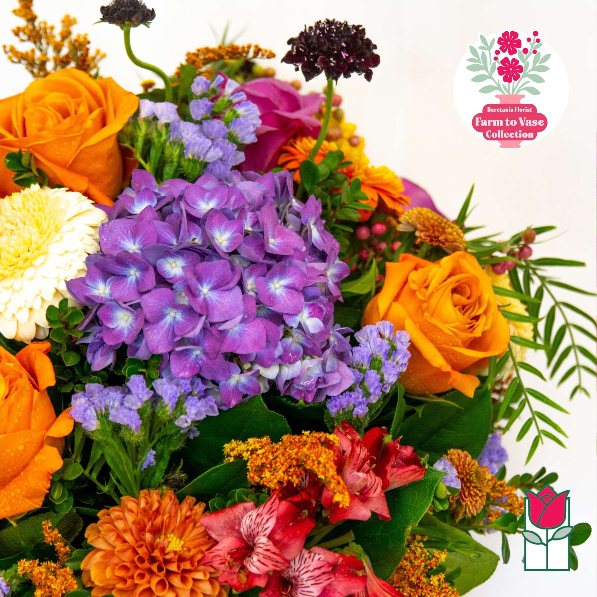 Colorful bouquet with orange roses, purple hydrangea, and mixed blooms