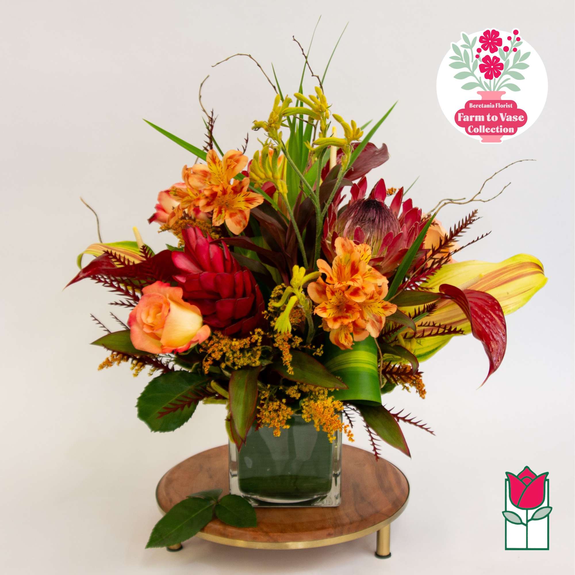 Tropical bouquet with orange and red flowers in a glass vase, photo 2 of 7