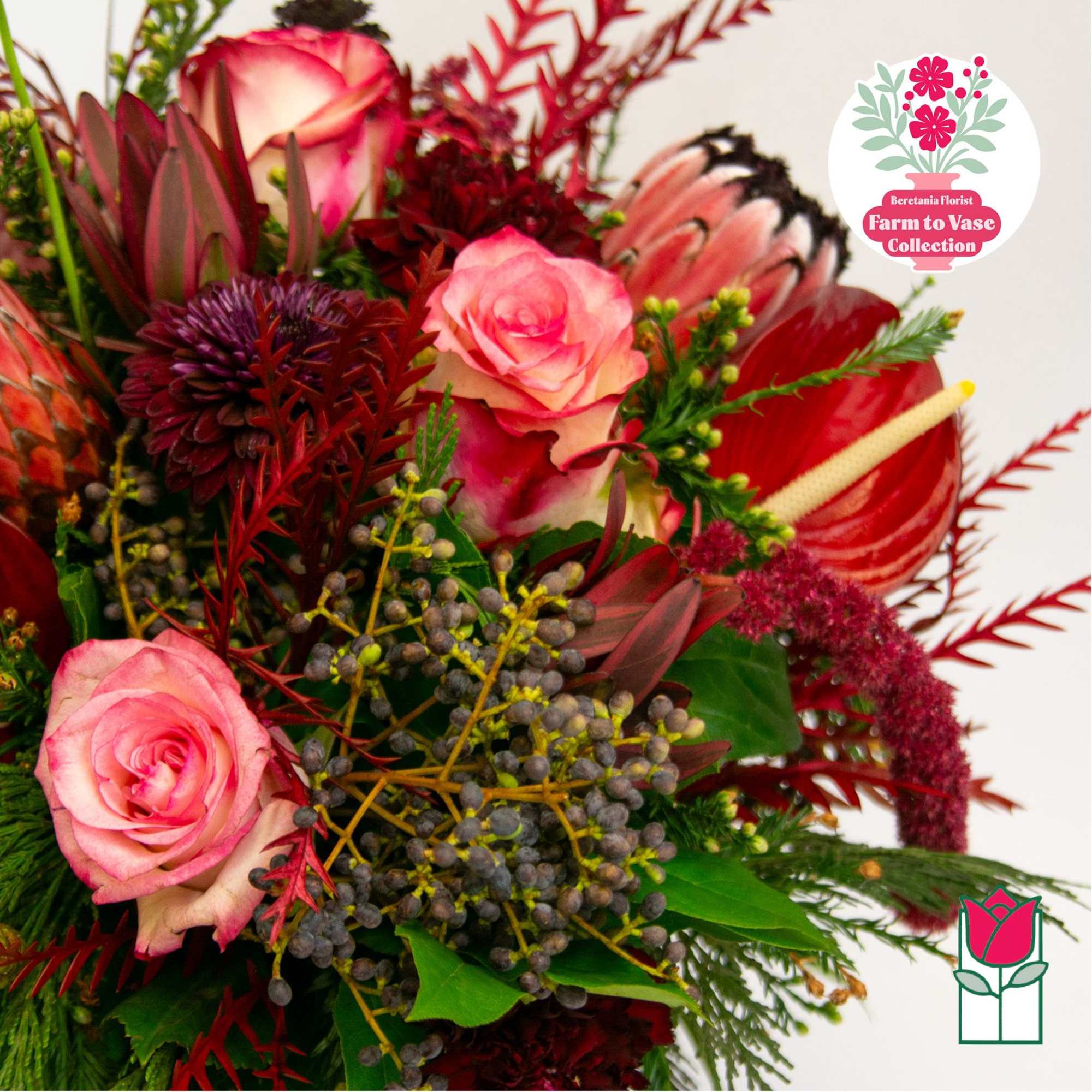 Bouquet of pink roses and red tropical flowers