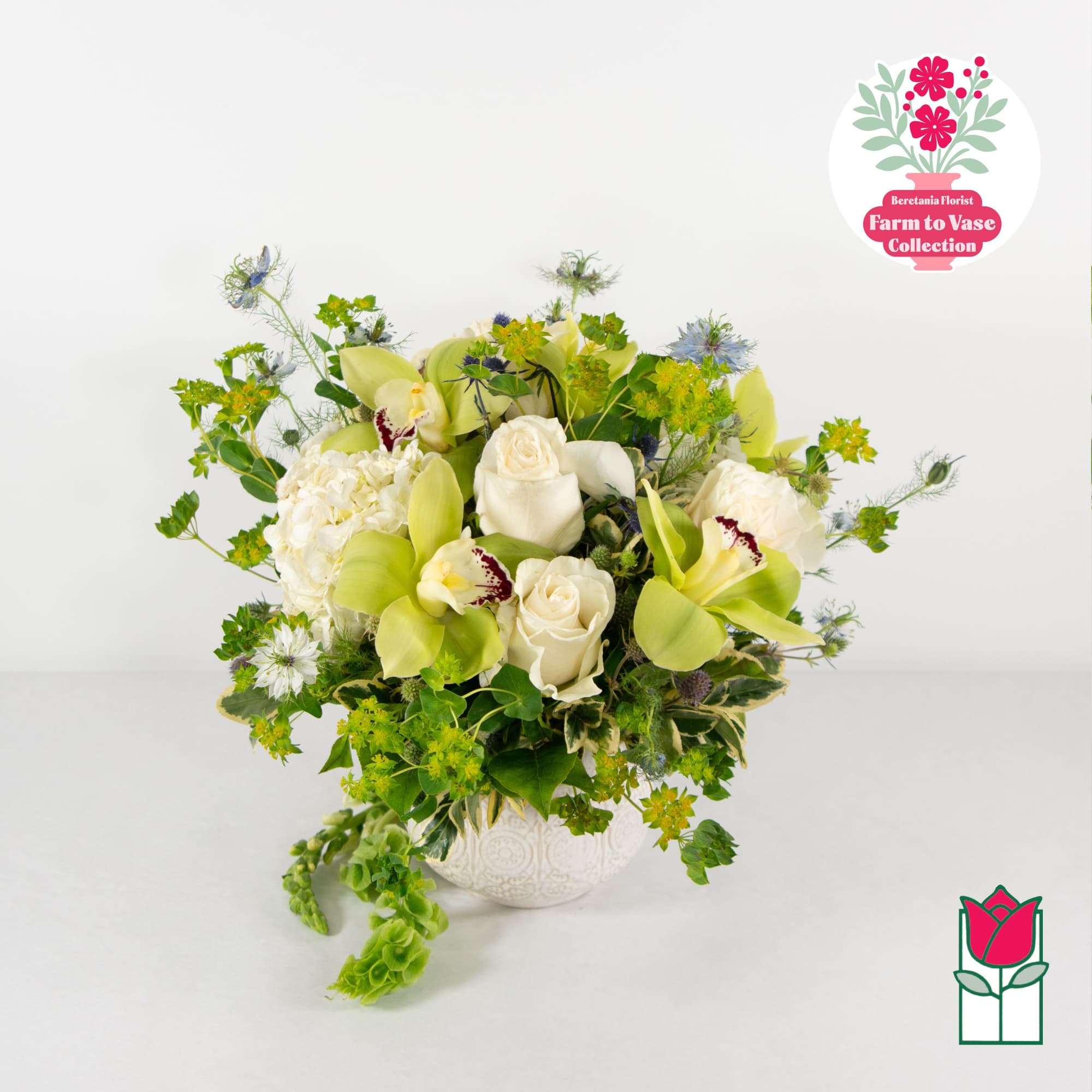 White and green floral arrangement in a decorative vase