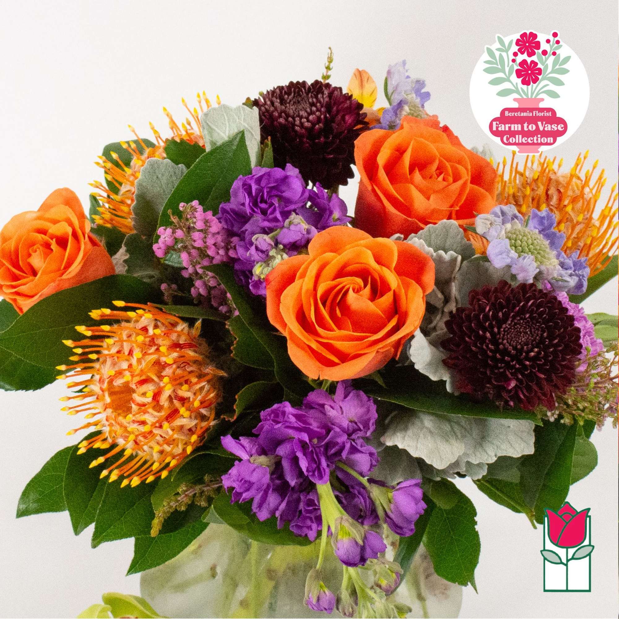 Bouquet of orange roses, purple blooms, and dark chrysanthemum flowers