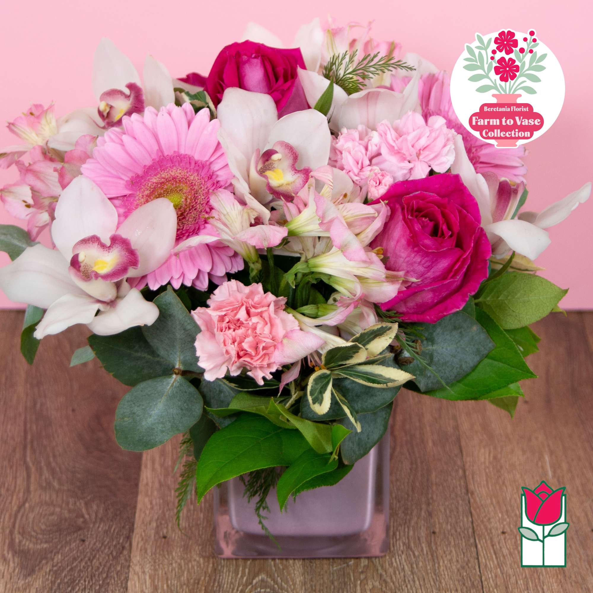 Pink and white mixed bouquet in a square glass vase