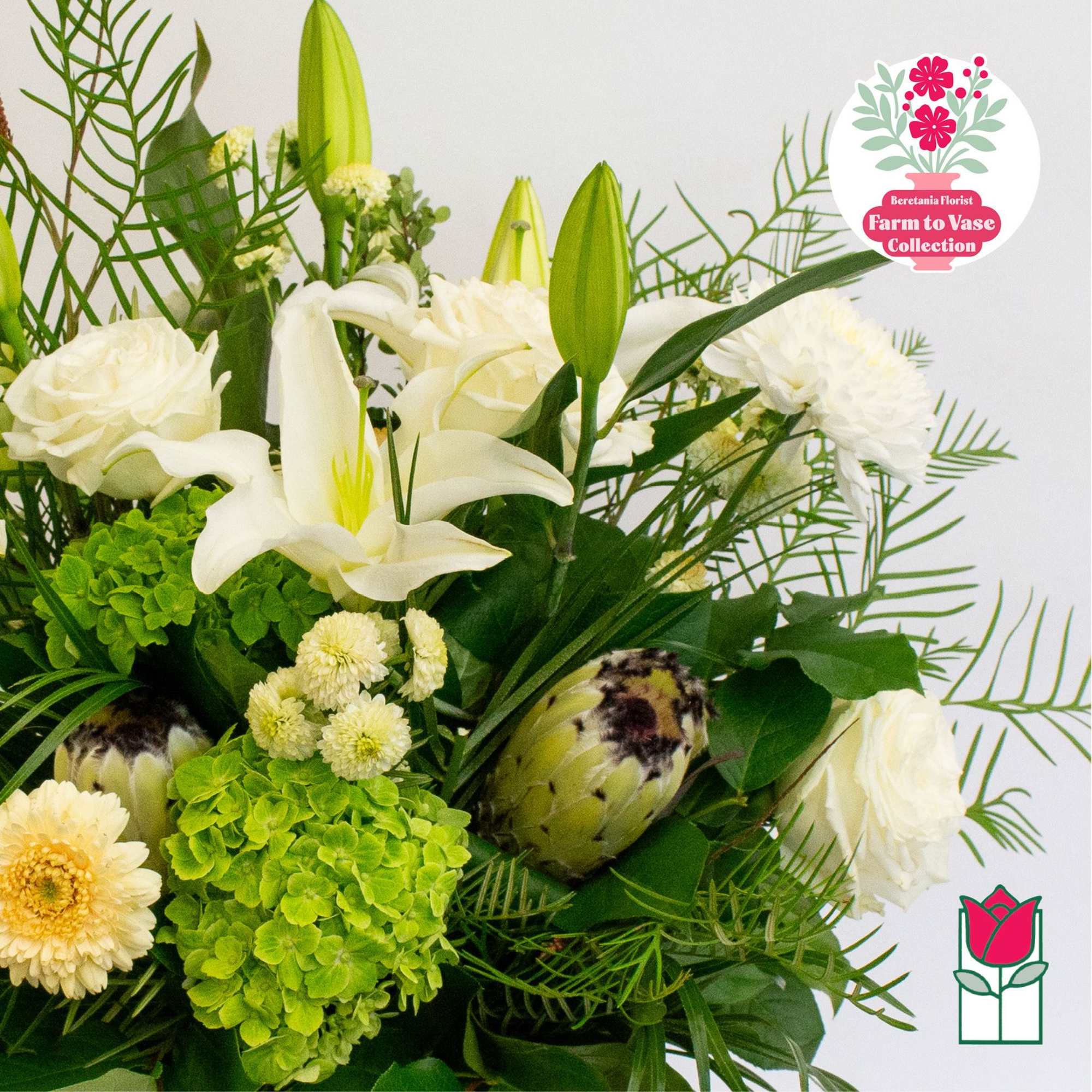 White lilies and roses with green hydrangea and protea in a bouquet