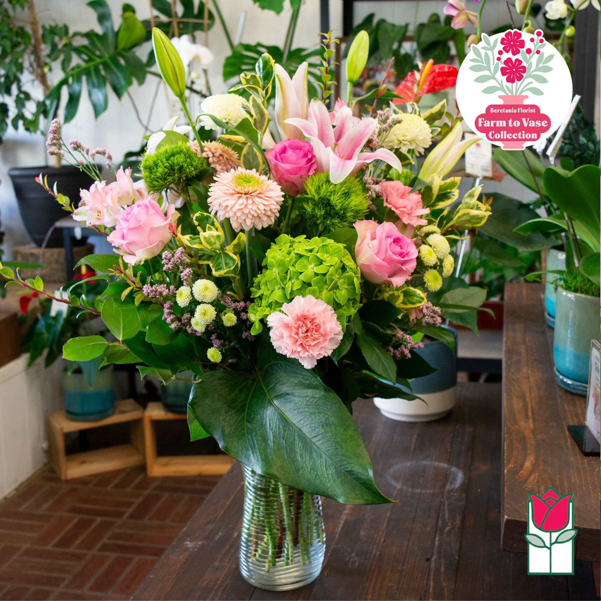 Mixed pink and white flower arrangement in a clear glass vase