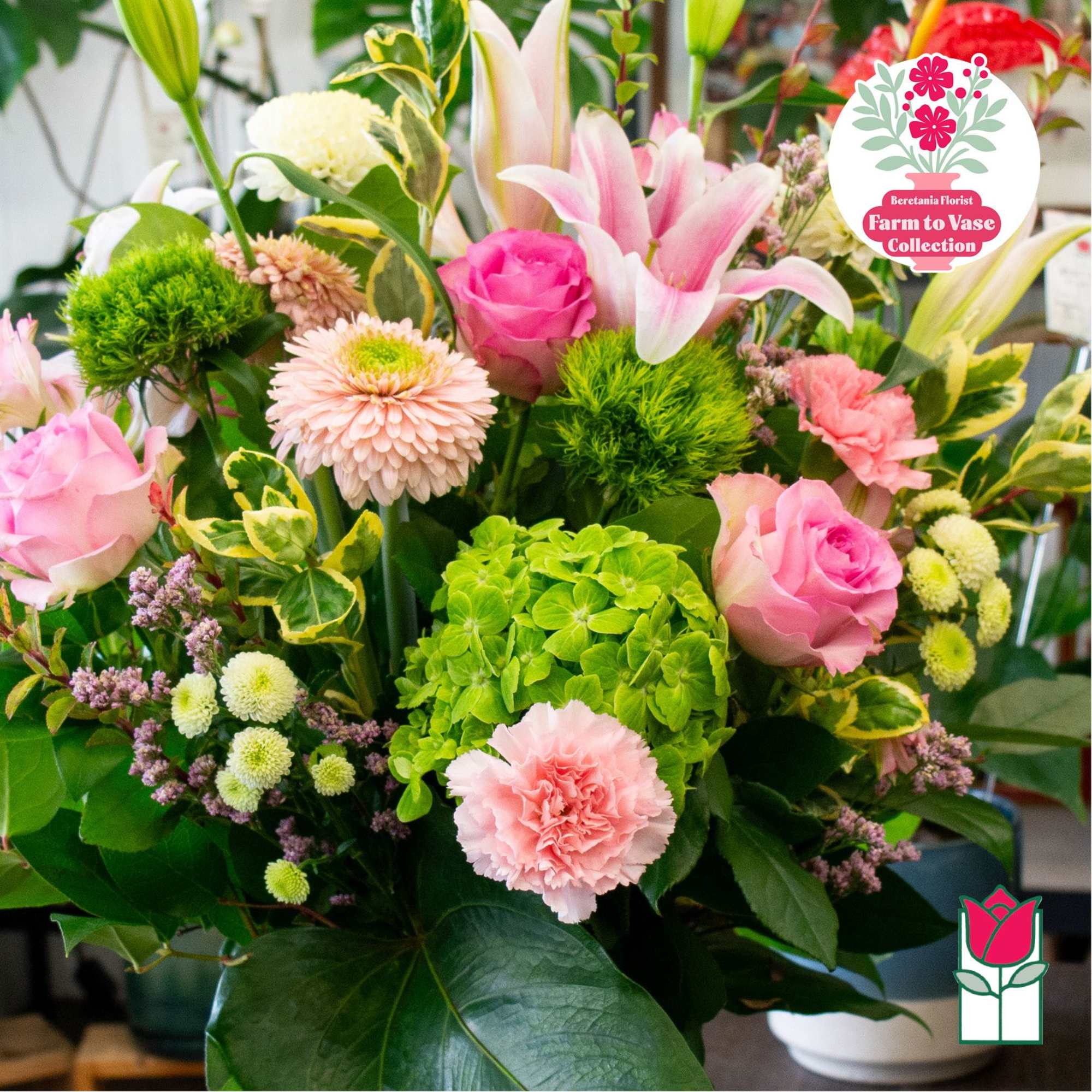 Pink roses and lilies with green hydrangea in a vase