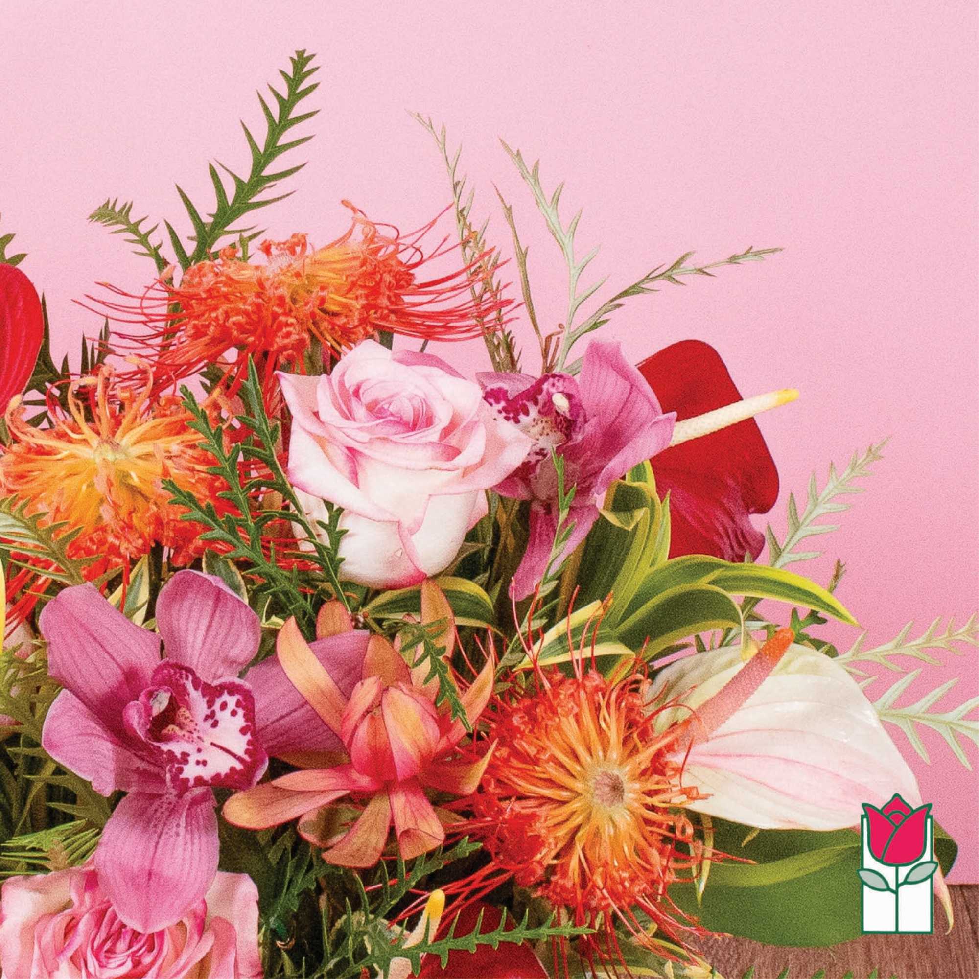 Bright arrangement of pink roses, orchids, and orange protea against a pink background