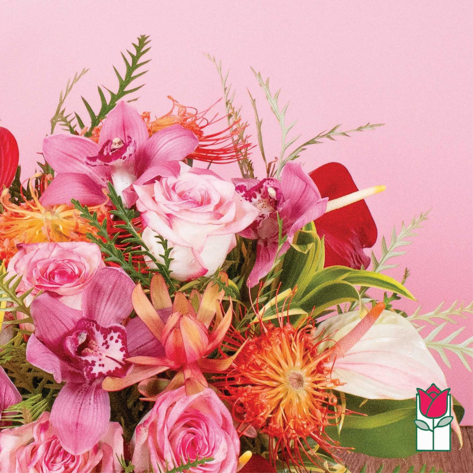 Bright mixed bouquet of pink roses, orchids, and orange protea against a pink background