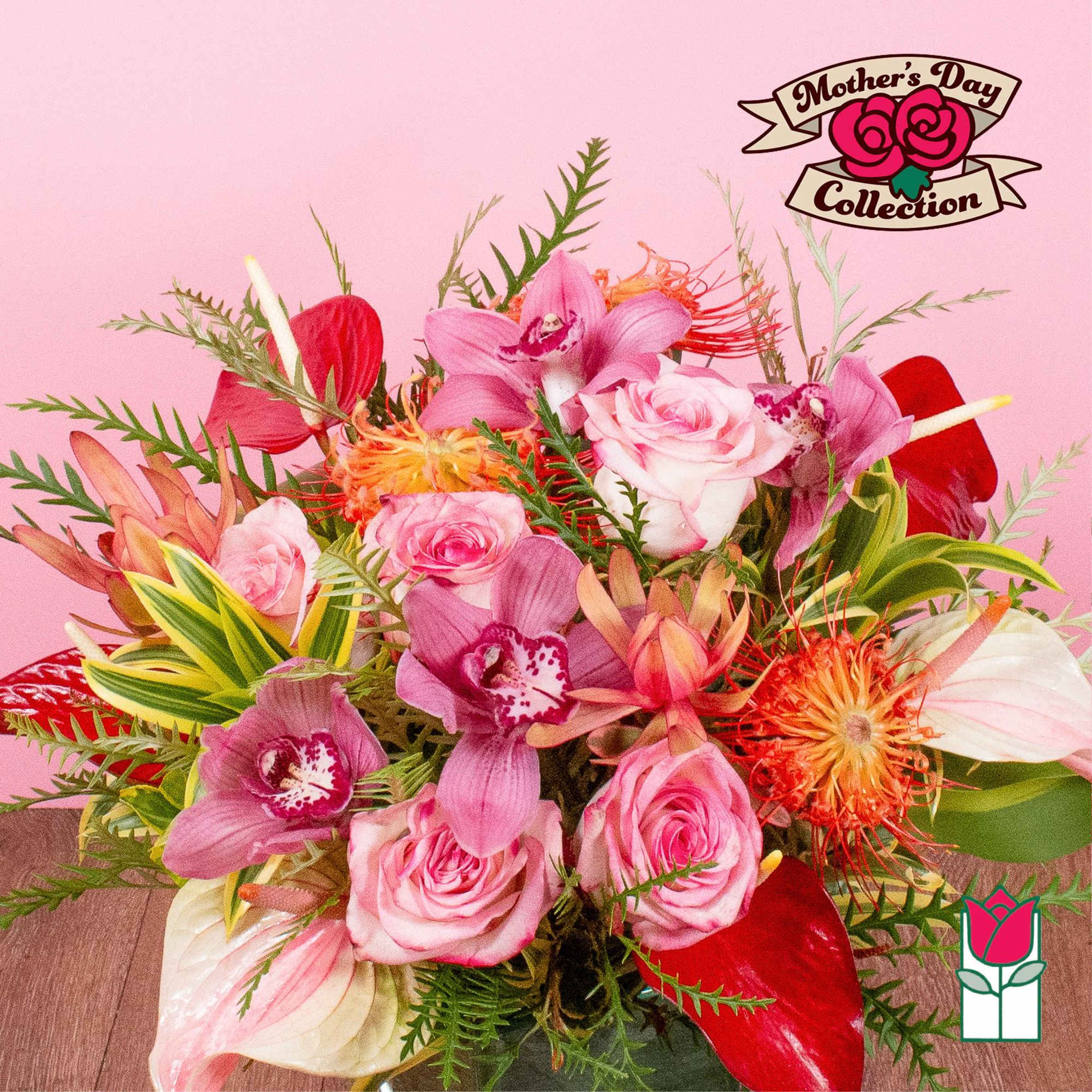 Mixed pink rose and orchid arrangement with red and orange tropical blooms in a vase against a pink background
