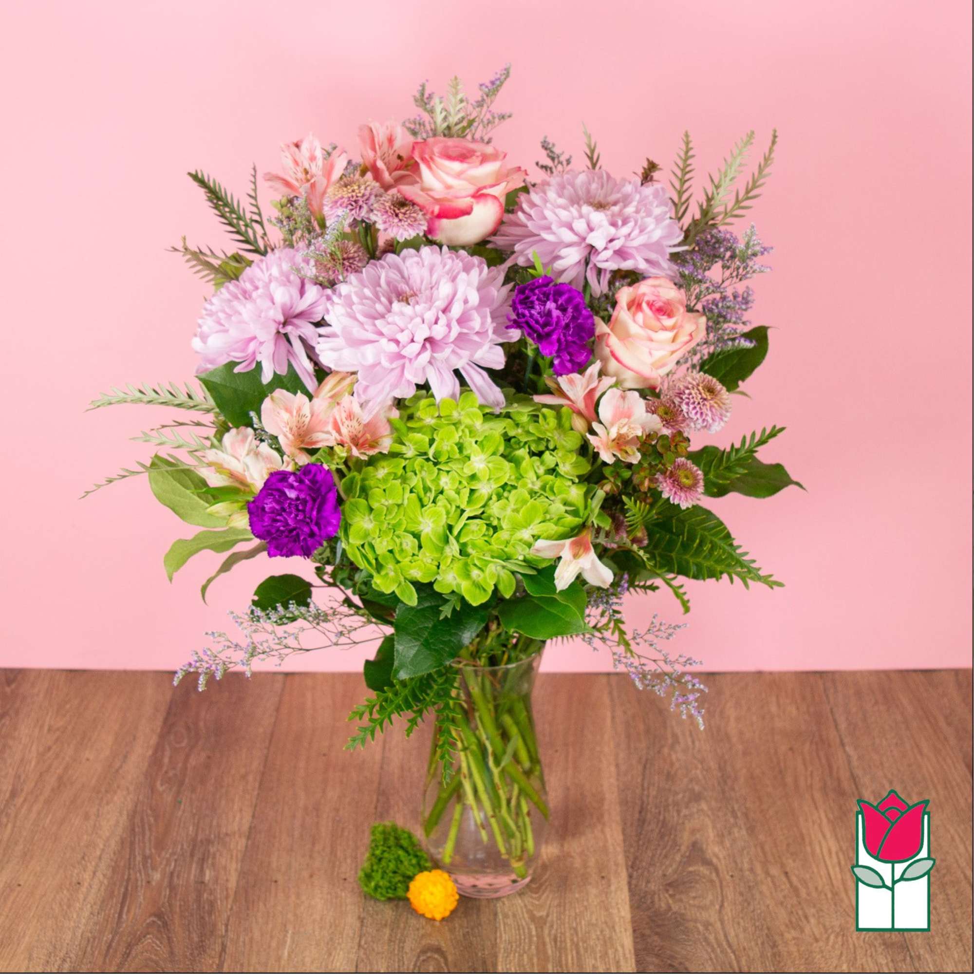 Bouquet of pink and purple flowers in a clear glass vase