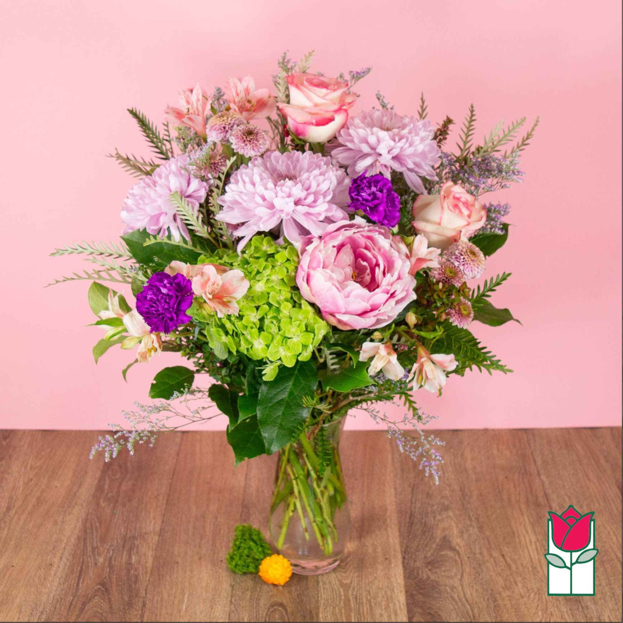Pink and purple mixed bouquet in a clear glass vase