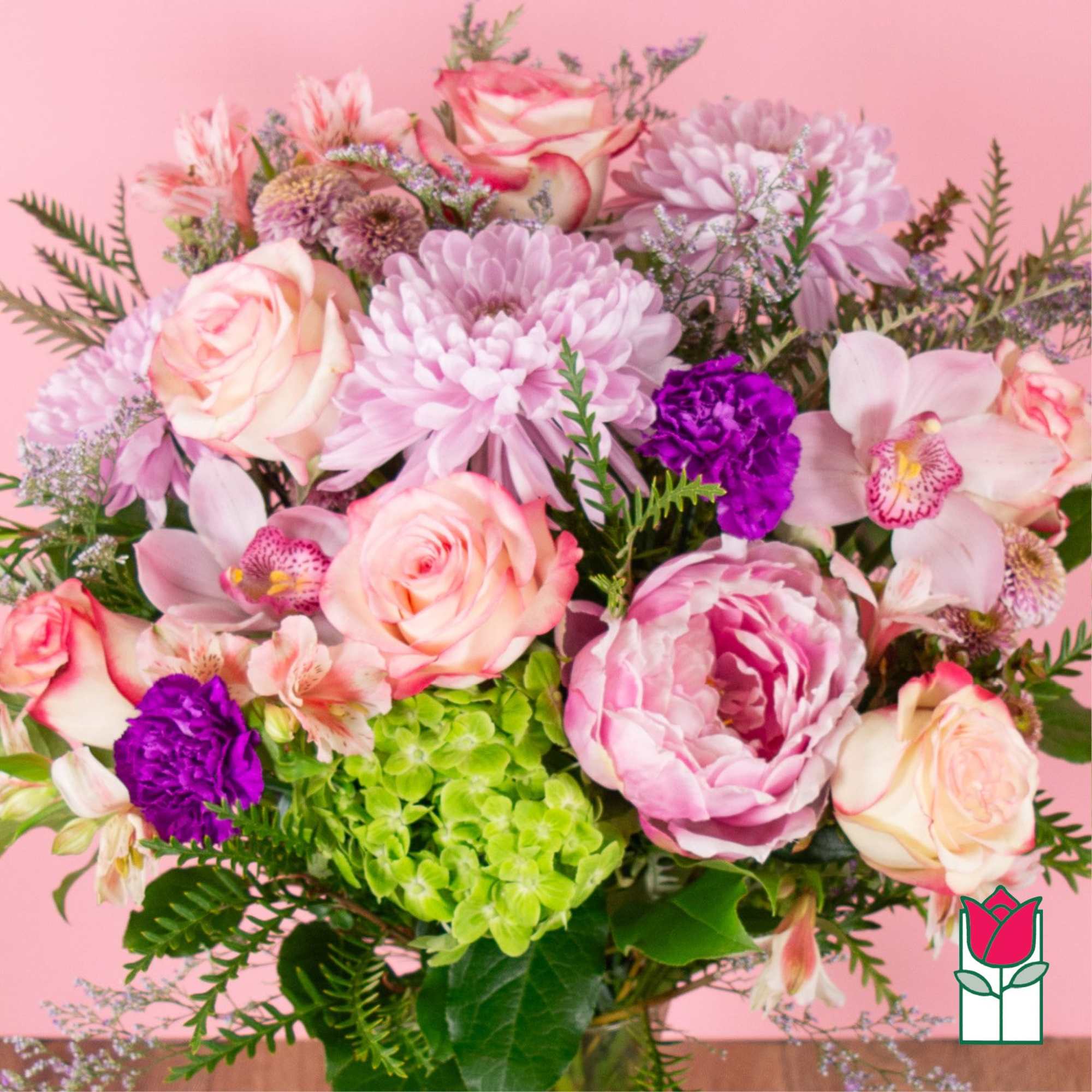 Pink and cream bouquet with roses, chrysanthemums, orchids, and hydrangea