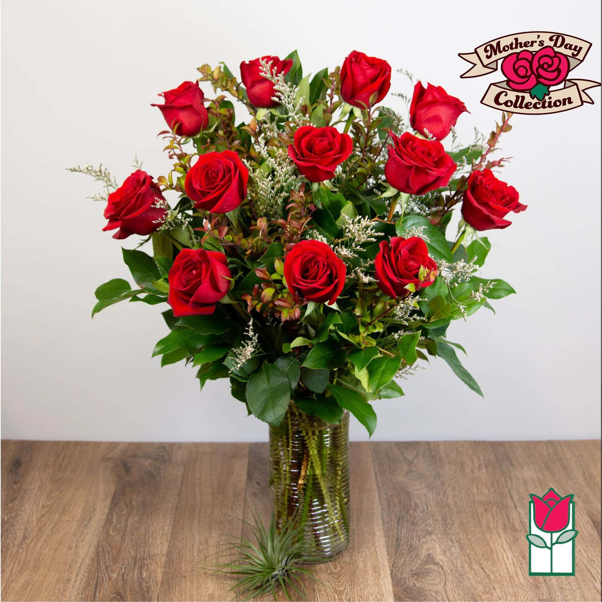 Red roses arranged in a clear glass vase