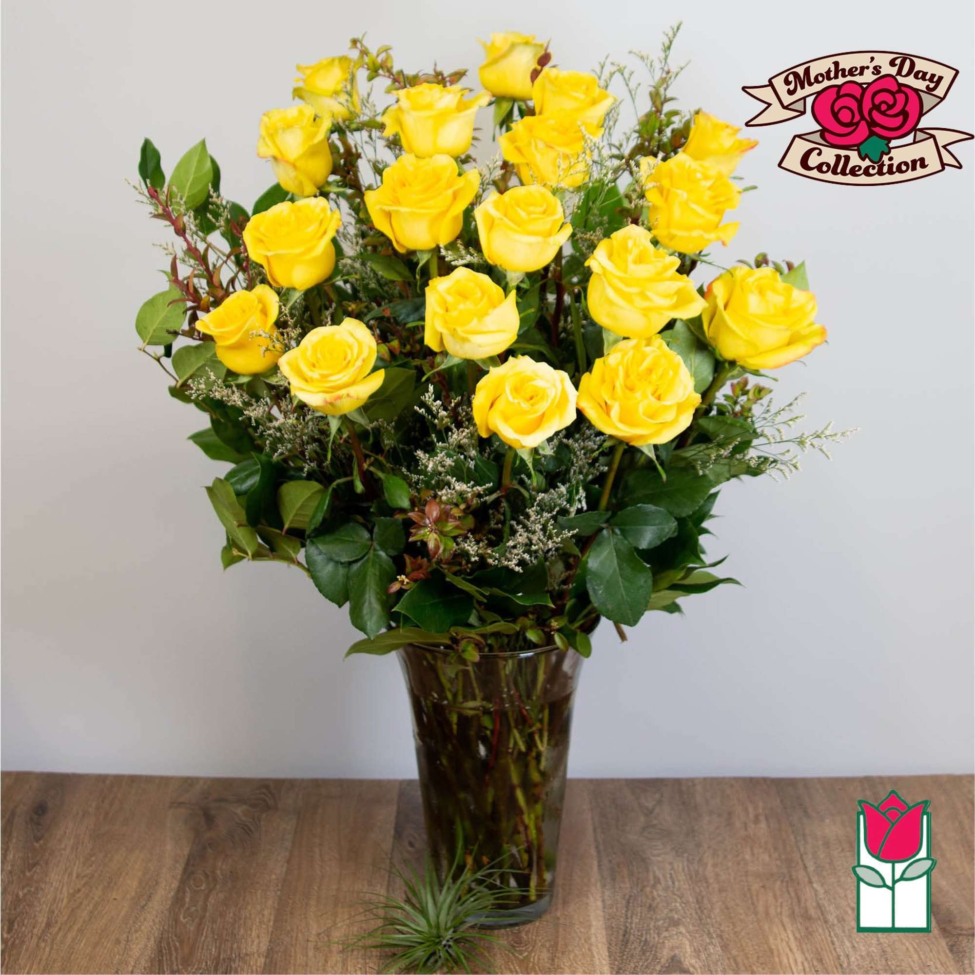 Yellow roses arranged in a tall glass vase, photo 5 of 5