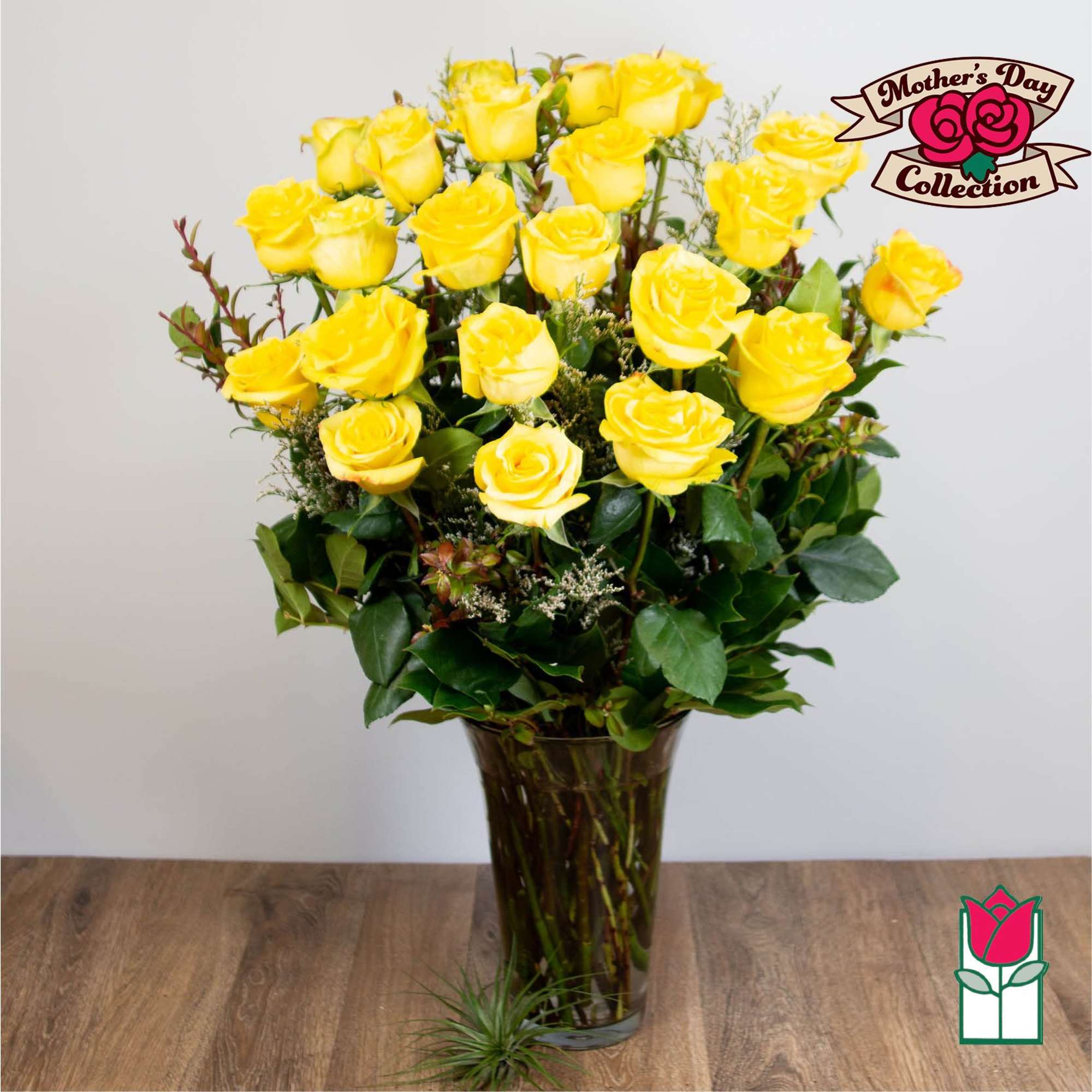 Tall bouquet of yellow roses in a glass vase