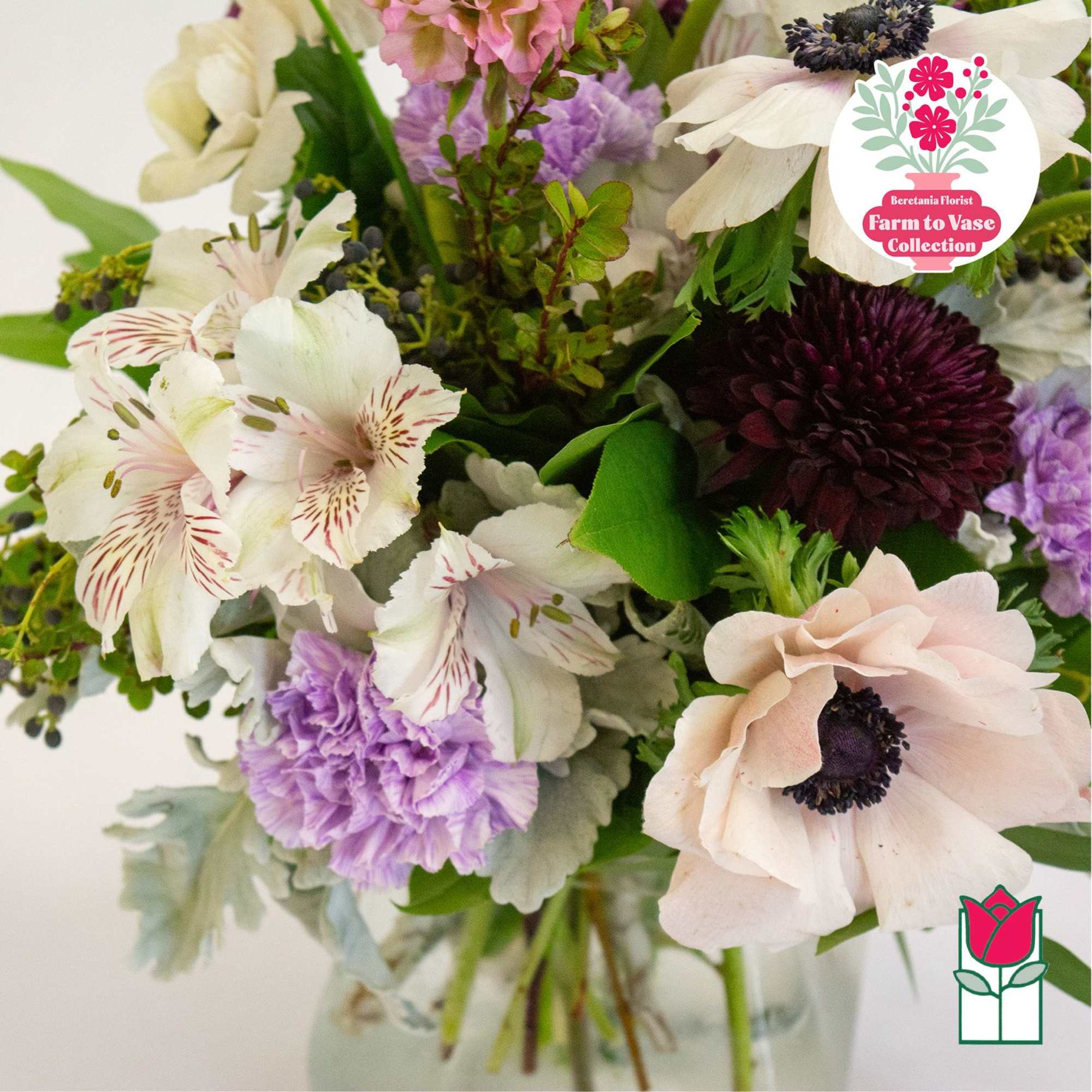Mixed bouquet of white, pink, and purple flowers in a glass vase, photo 4 of 6