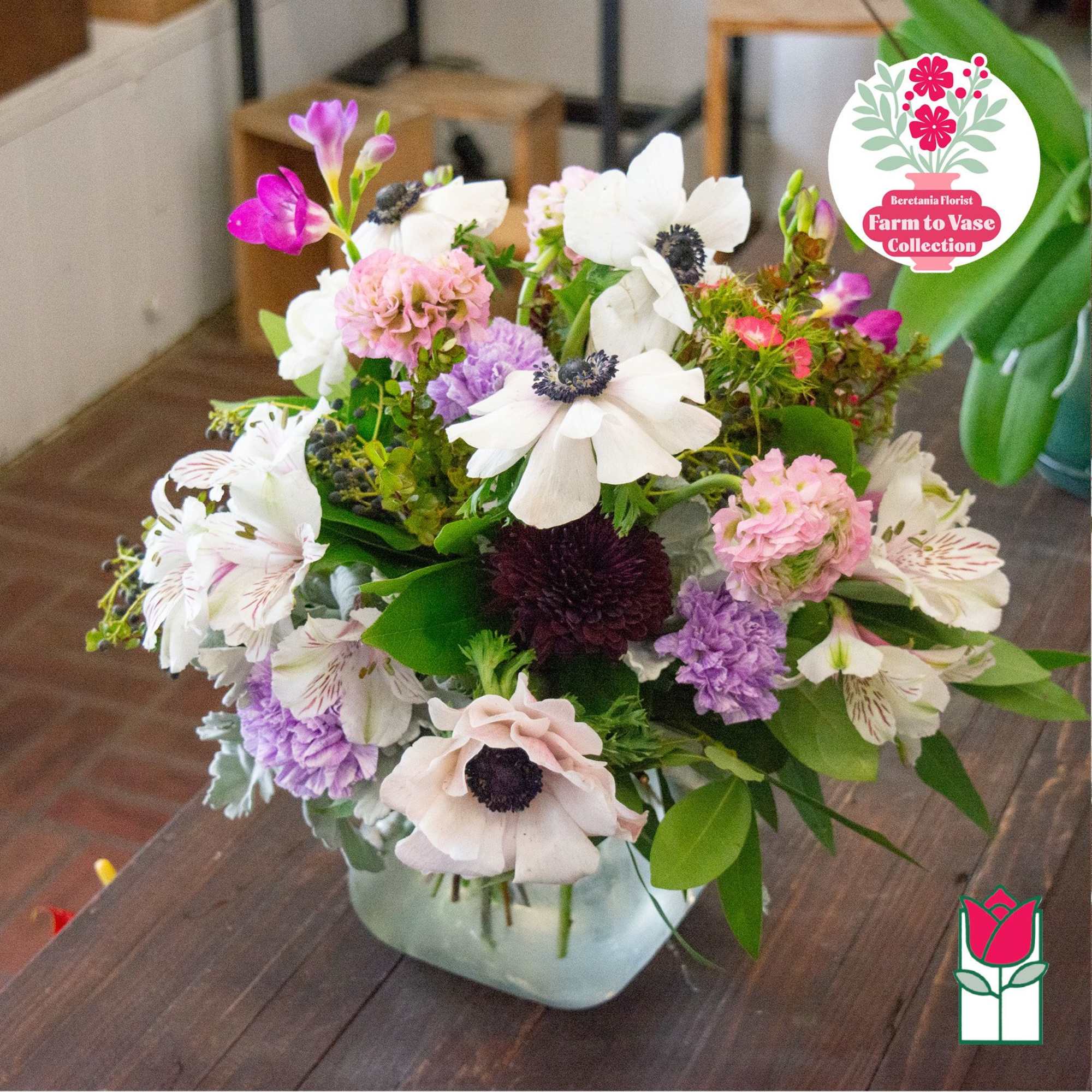 Mixed bouquet of white, pink, and purple flowers in a glass vase, photo 5 of 6