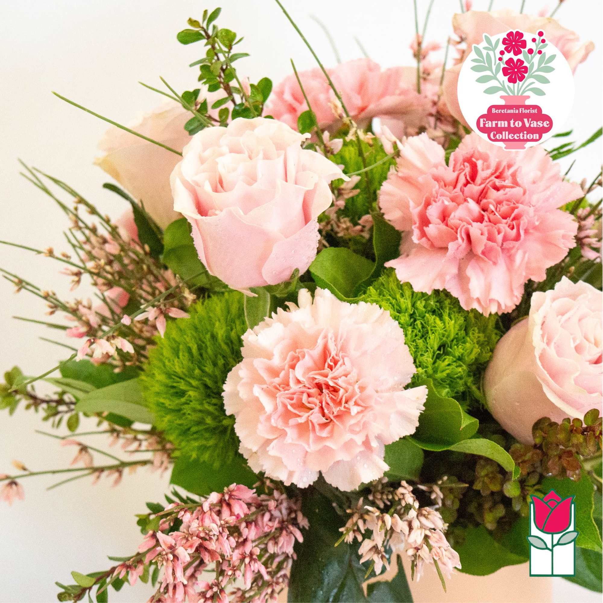 Pink roses and carnations arranged with greenery in a bouquet, photo 4 of 7