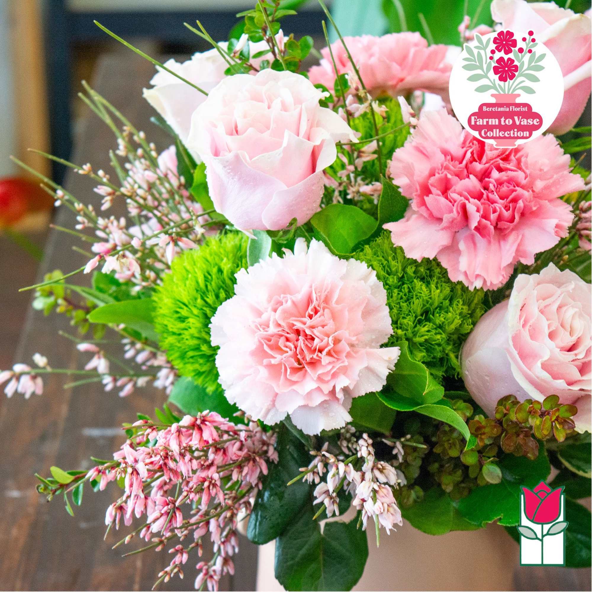 Pink roses and carnations arranged in a vase