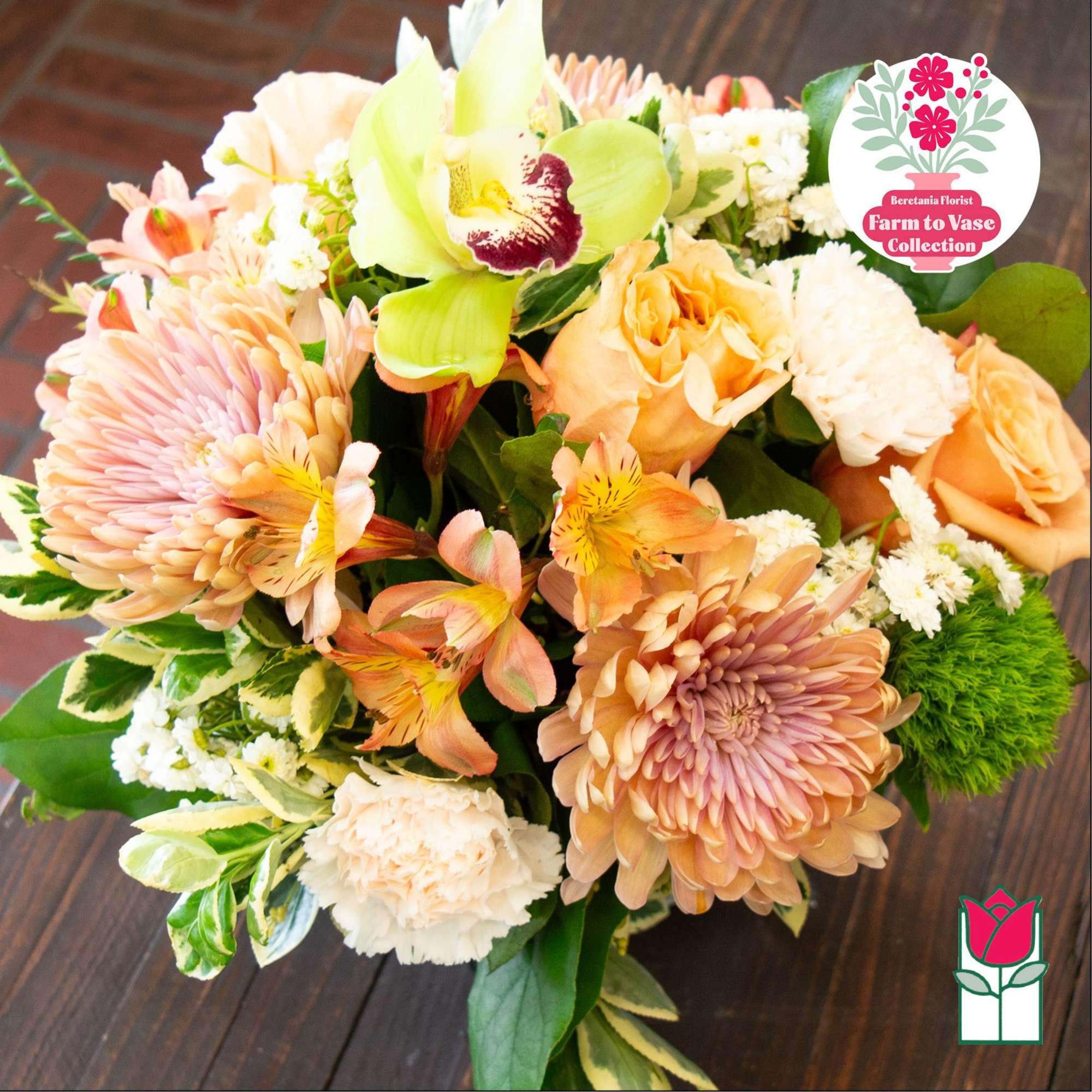 Mixed bouquet with peach roses, chrysanthemums, and a green orchid.