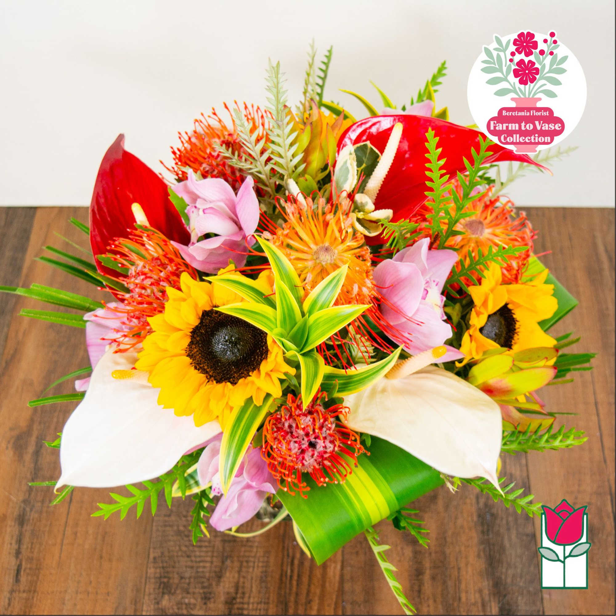 Tropical bouquet with sunflowers, red anthuriums, and white calla lilies