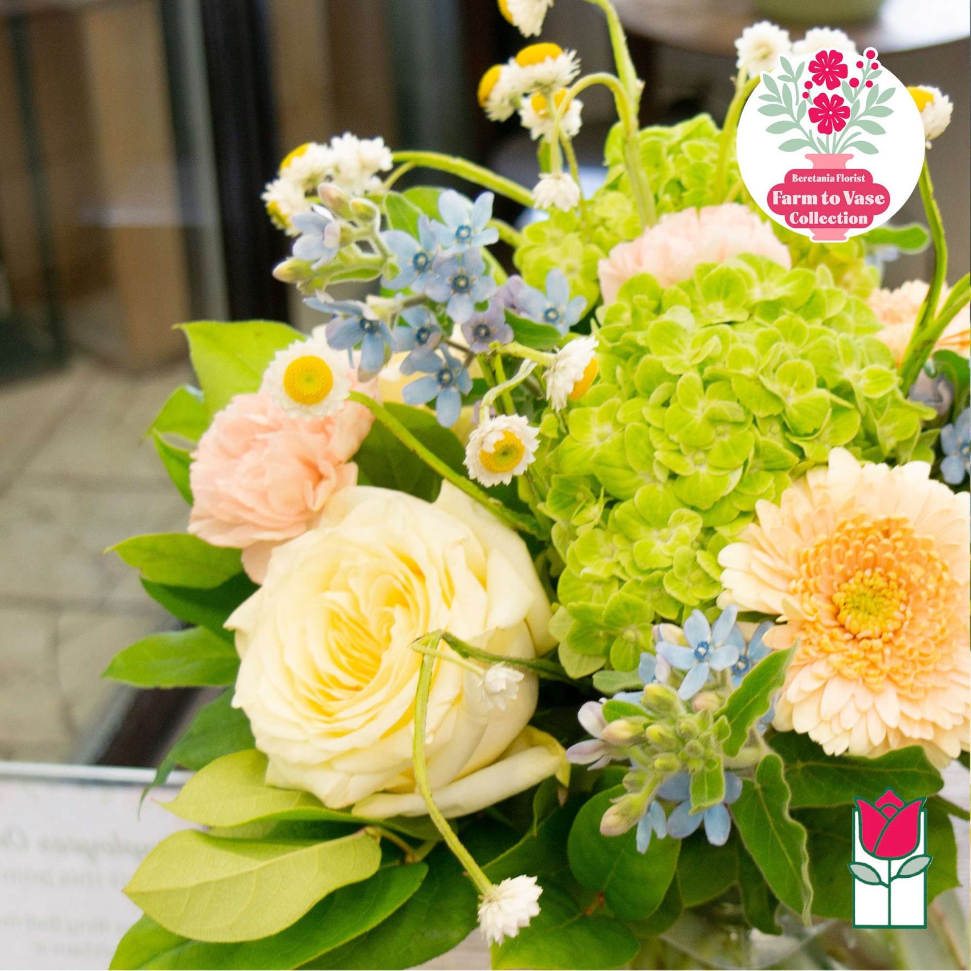 Bouquet with cream roses, green hydrangea, and peach daisies
