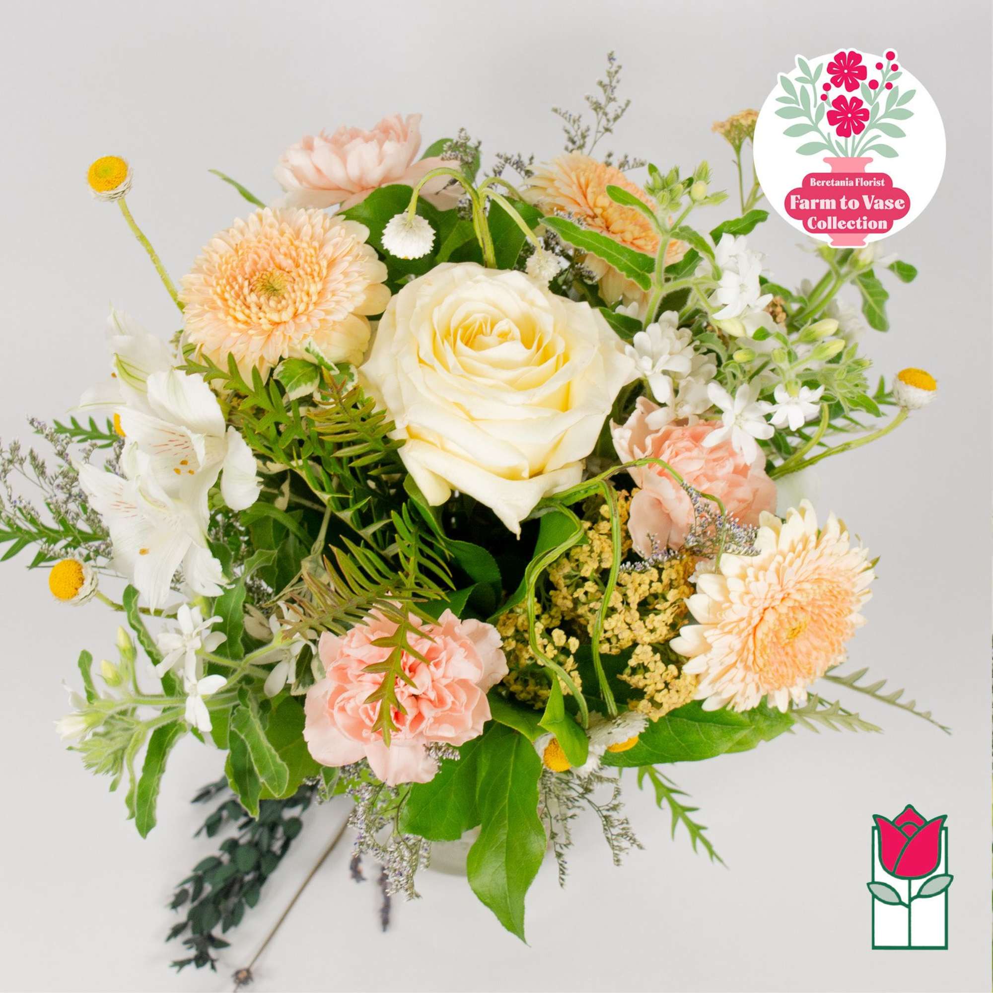 Mixed bouquet with a white rose, peach blooms, and white flowers