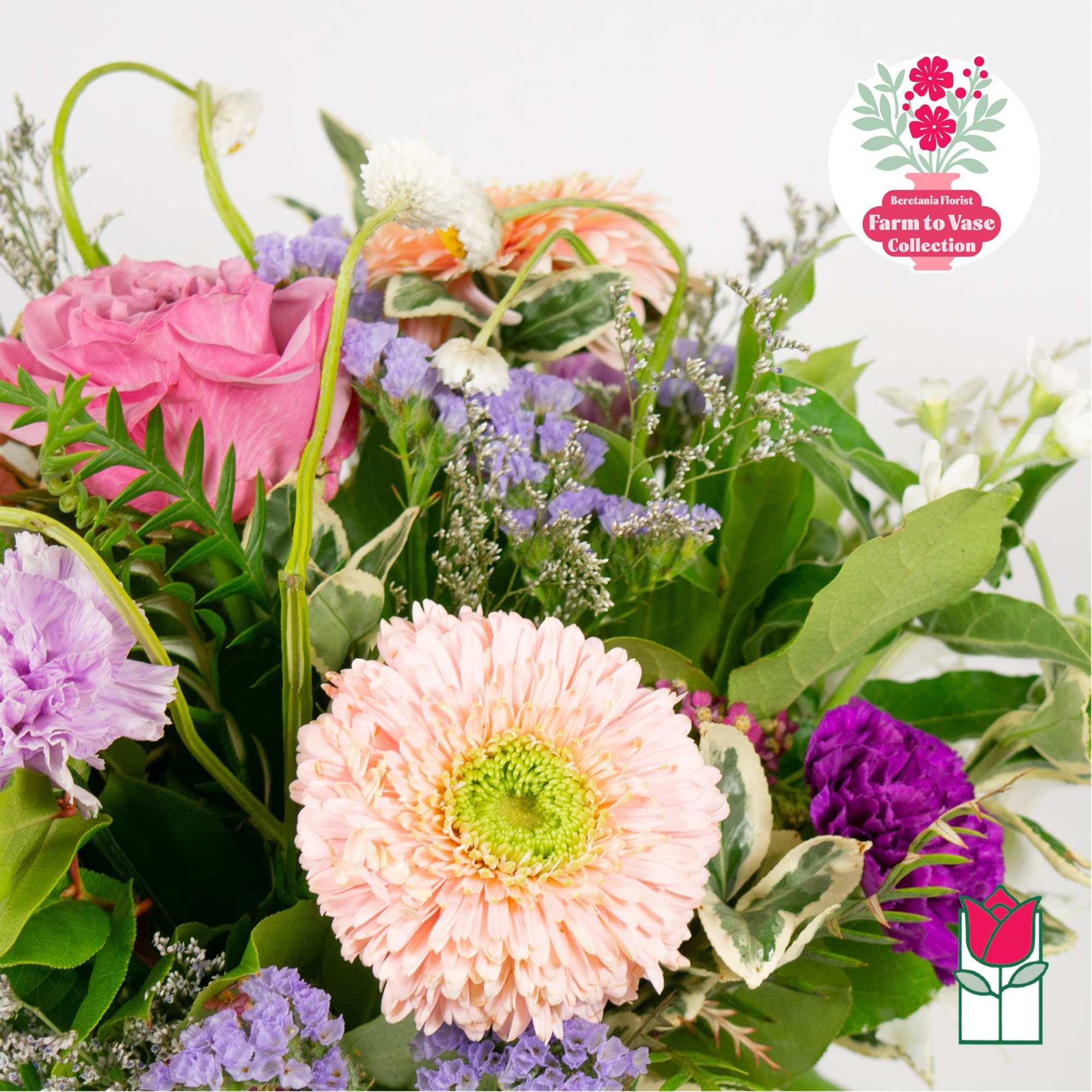 Mixed bouquet with pink and peach blooms in a loose arrangement