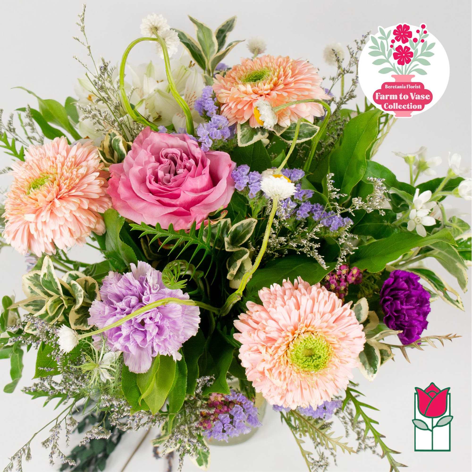 Mixed bouquet with pink rose, peach daisies, and purple blooms