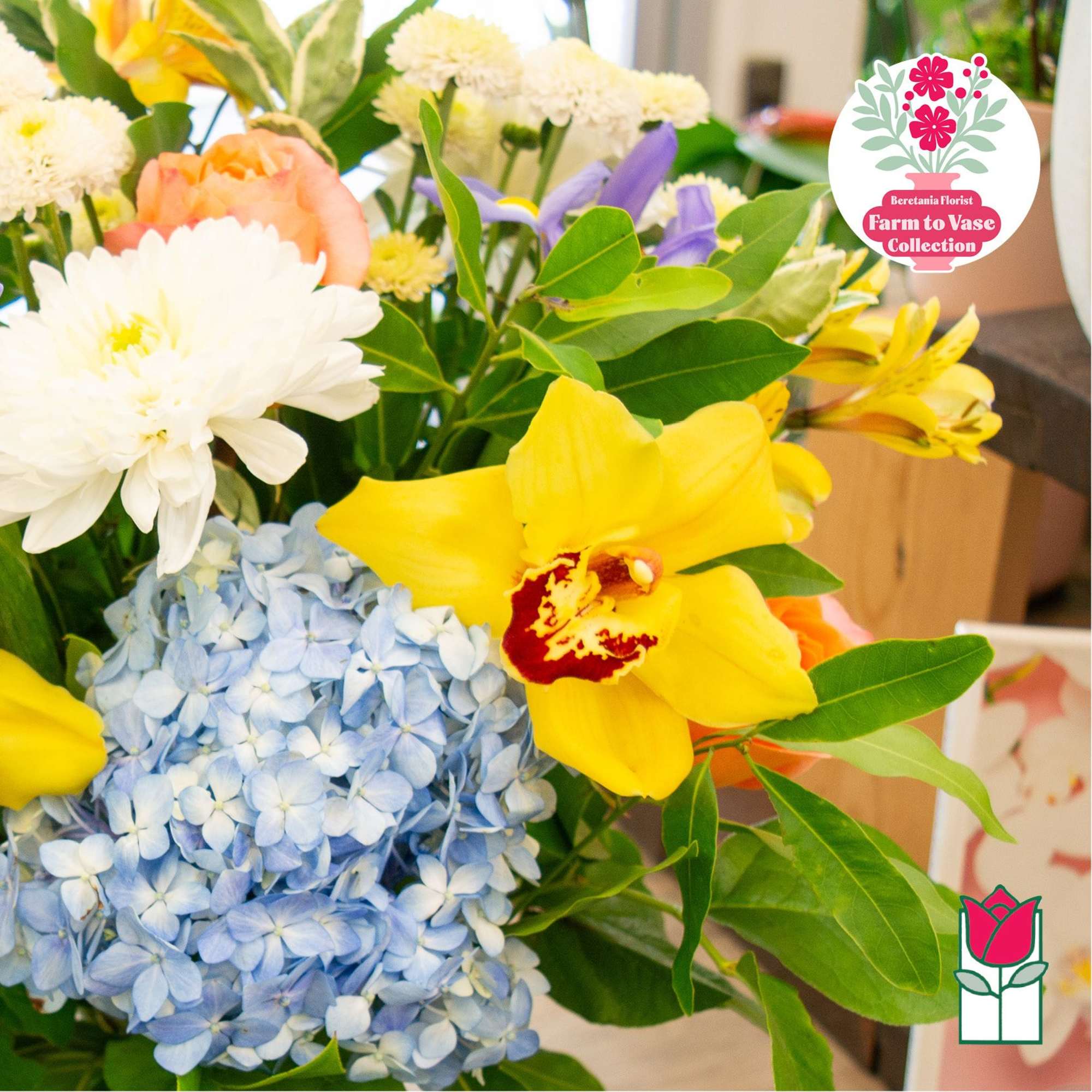 Mixed bouquet with blue hydrangea, yellow orchid, and white blooms