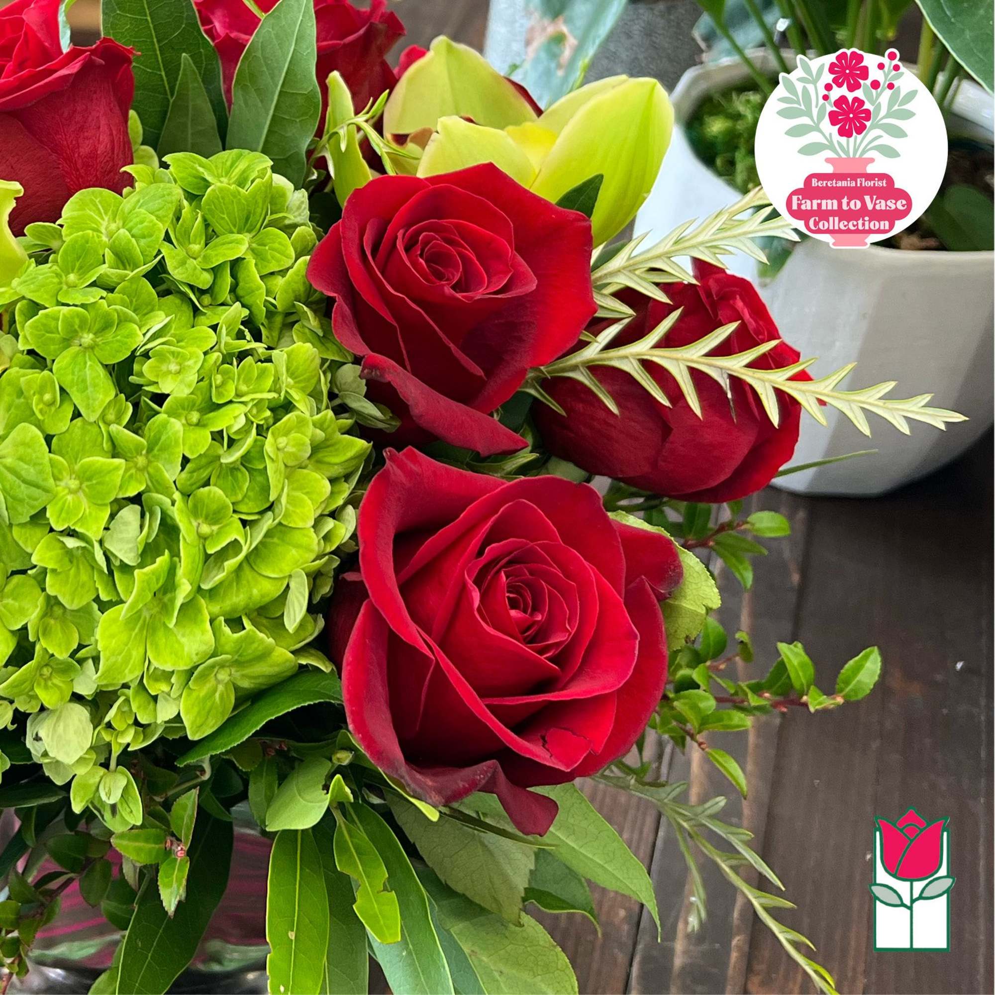 Bouquet of red roses and green hydrangea with pale yellow lilies