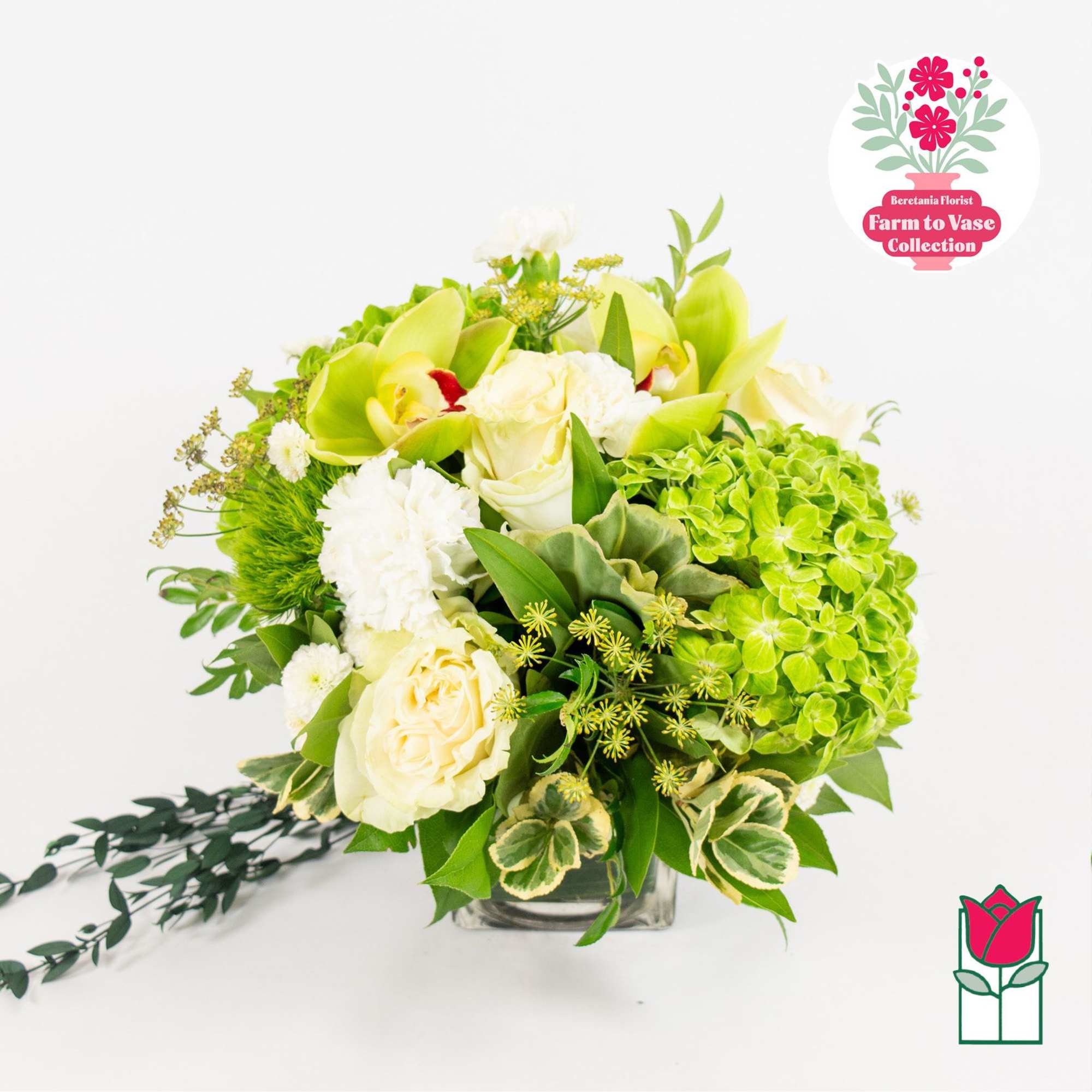 White and green floral arrangement in a clear glass vase