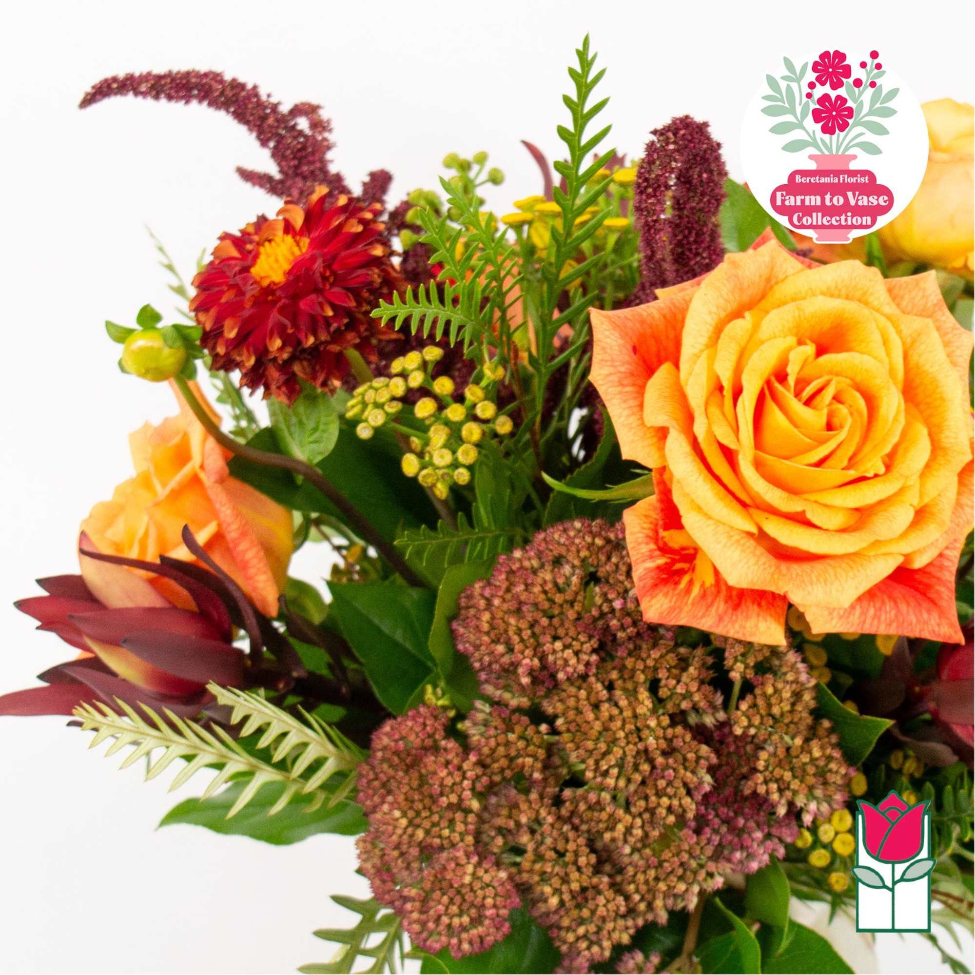 Bouquet of orange roses and burgundy flowers with mixed greenery