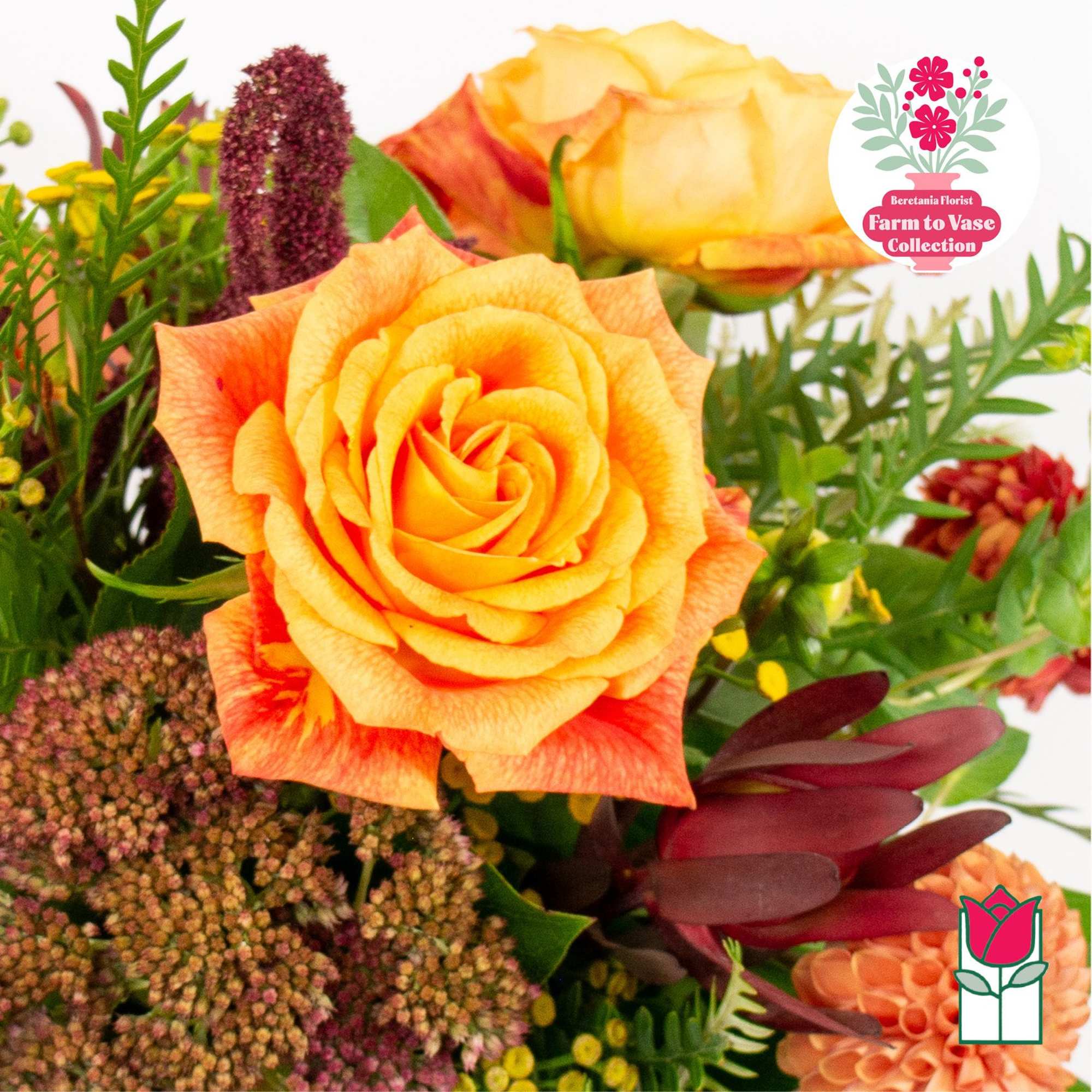 Orange and yellow roses with mixed flowers in a bouquet