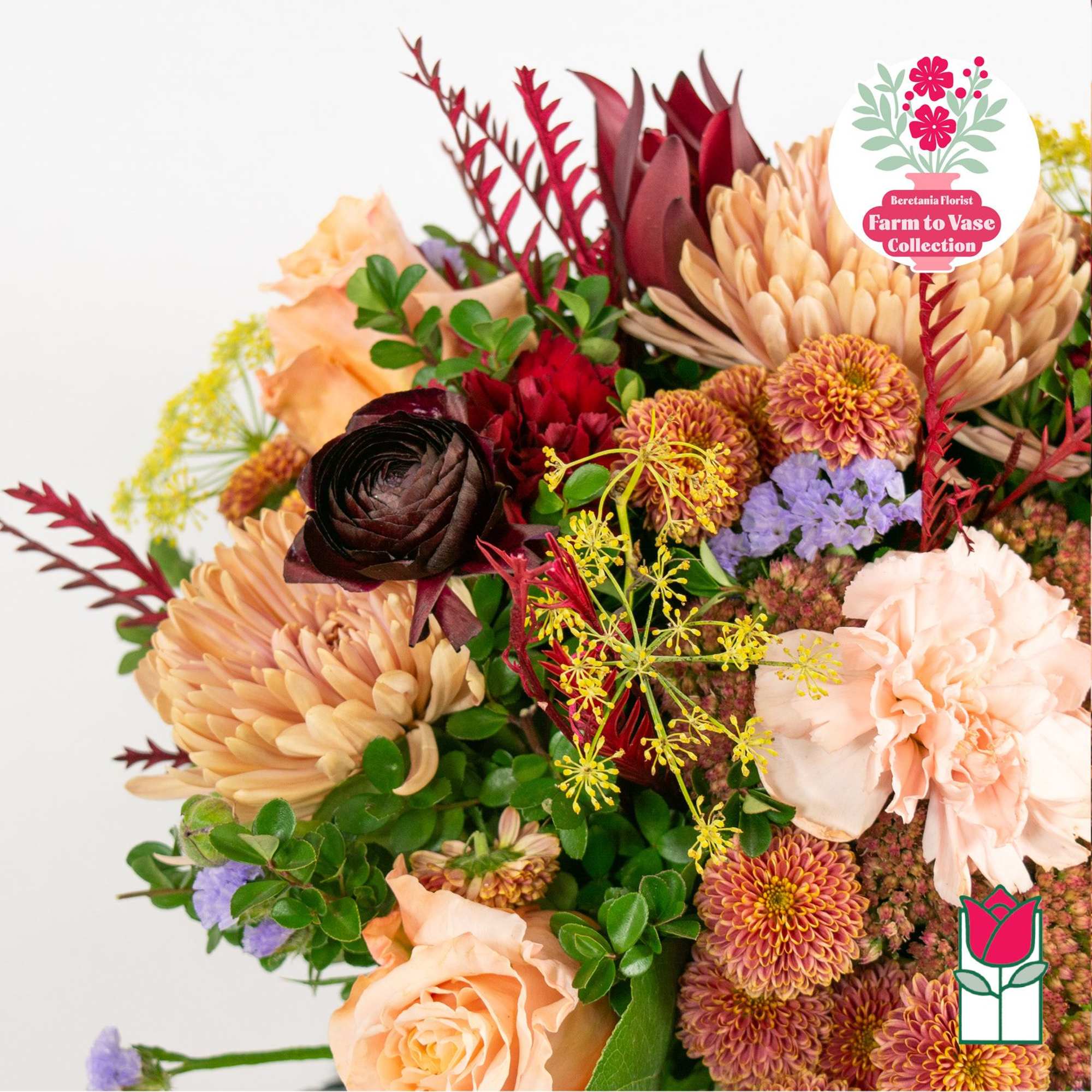 Mixed bouquet with peach roses, chrysanthemums, and dark red blooms