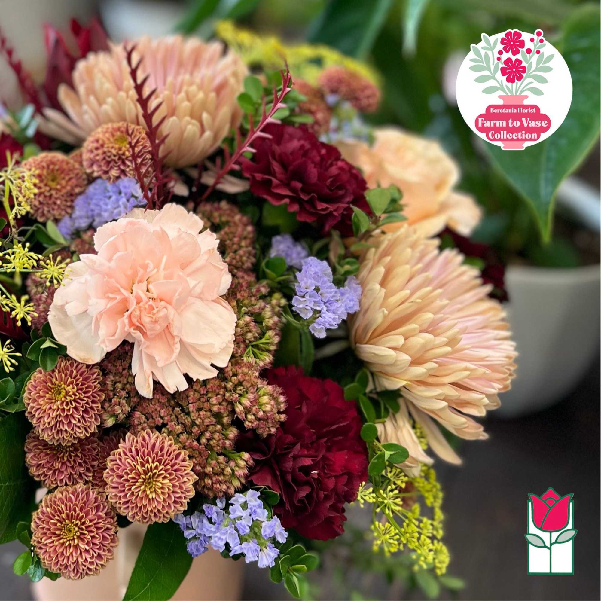 Mixed bouquet with peach, burgundy, and lavender flowers