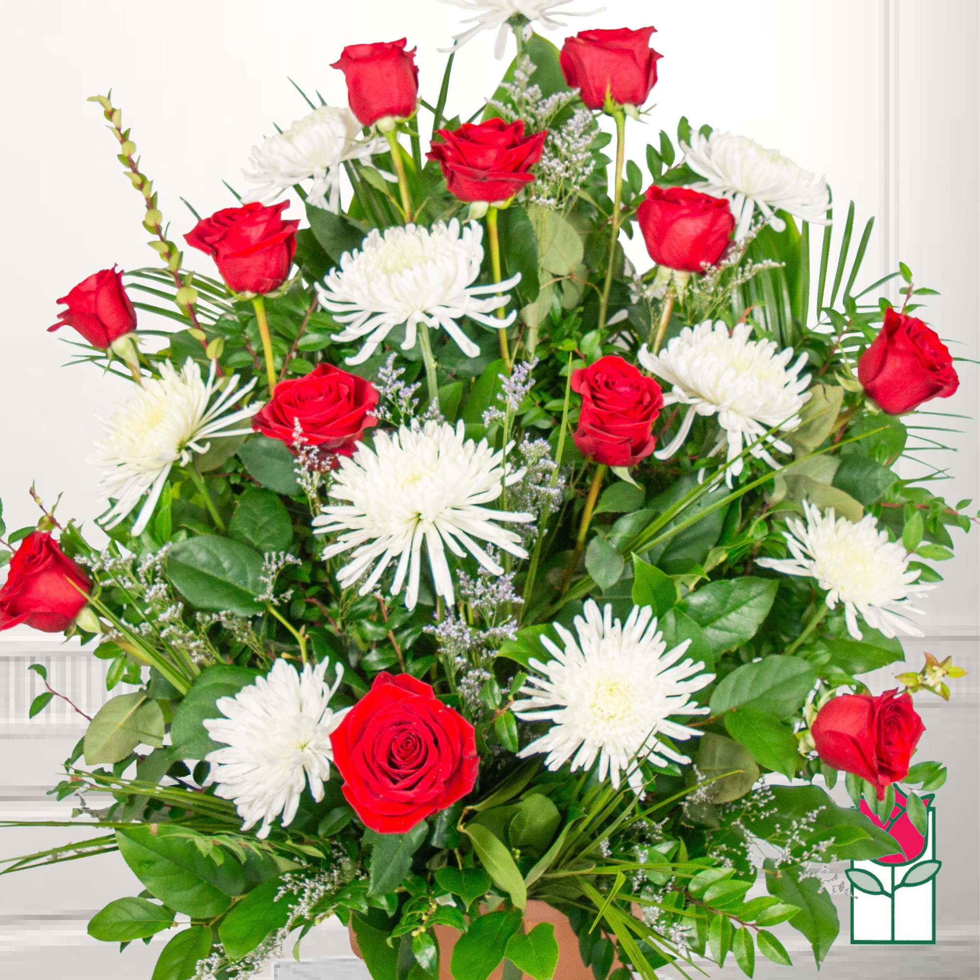 Bouquet of red roses and white spider mums with greenery