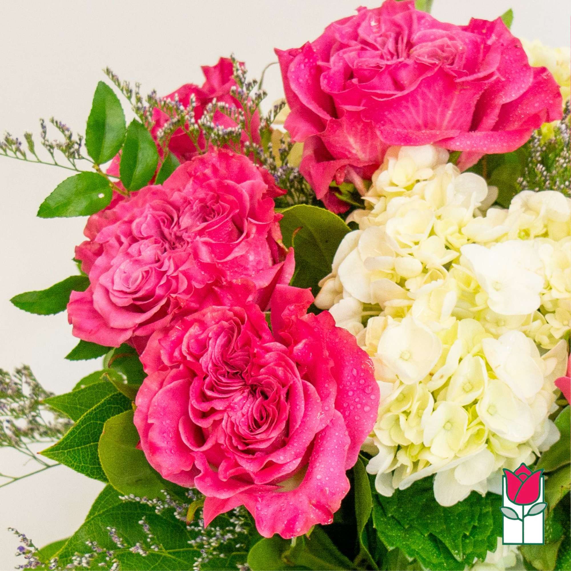 Pink roses with white hydrangeas and green foliage