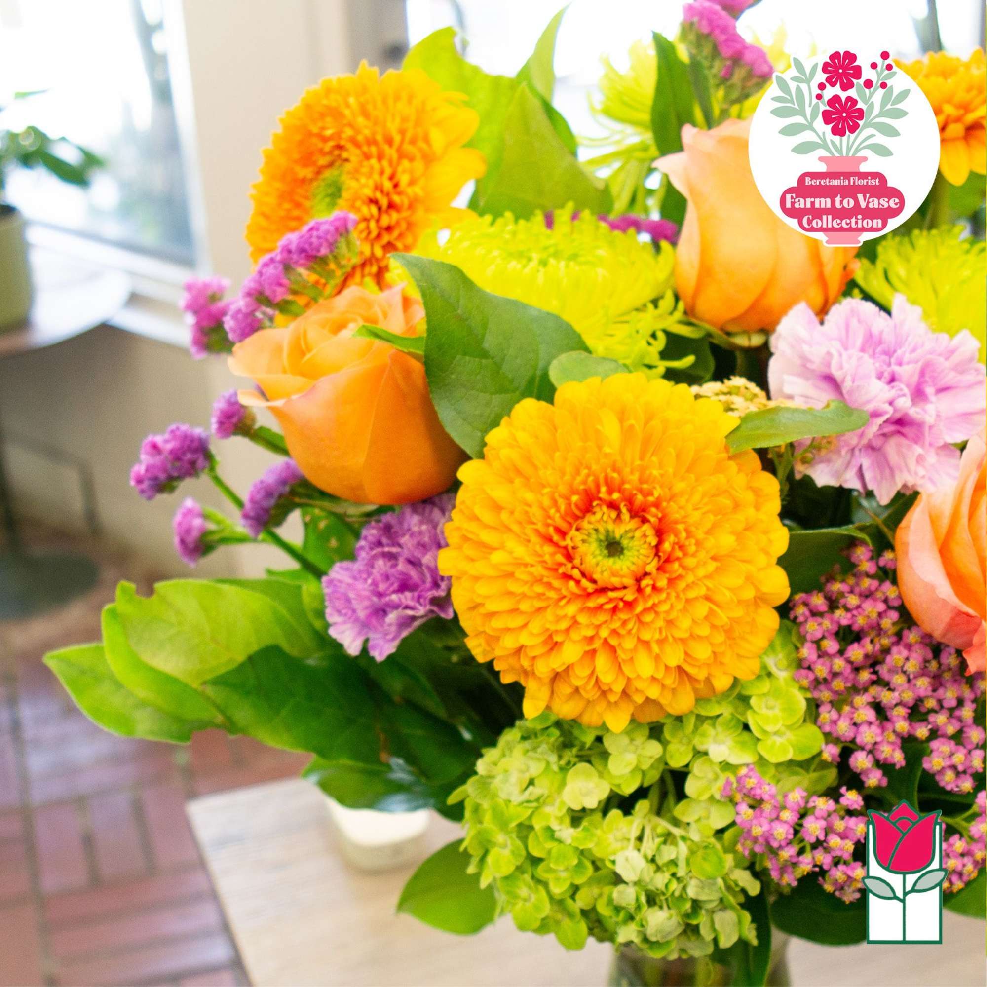 Bouquet of orange roses and yellow flowers in a vase